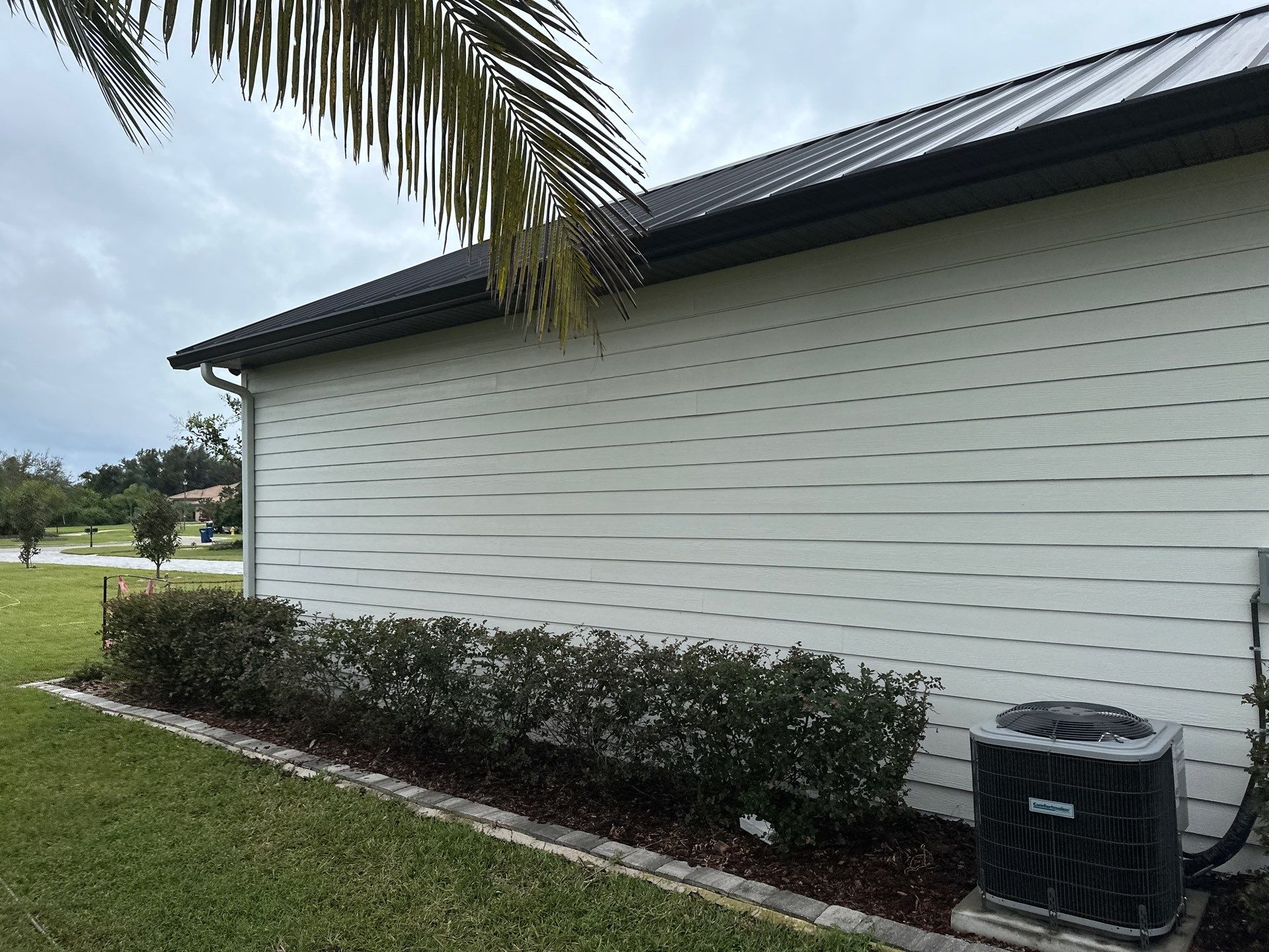 Complete Two-Story House Wash and Driveway Cleaning in Winding River Community, Bradenton, FL by Sunshine AquaWash