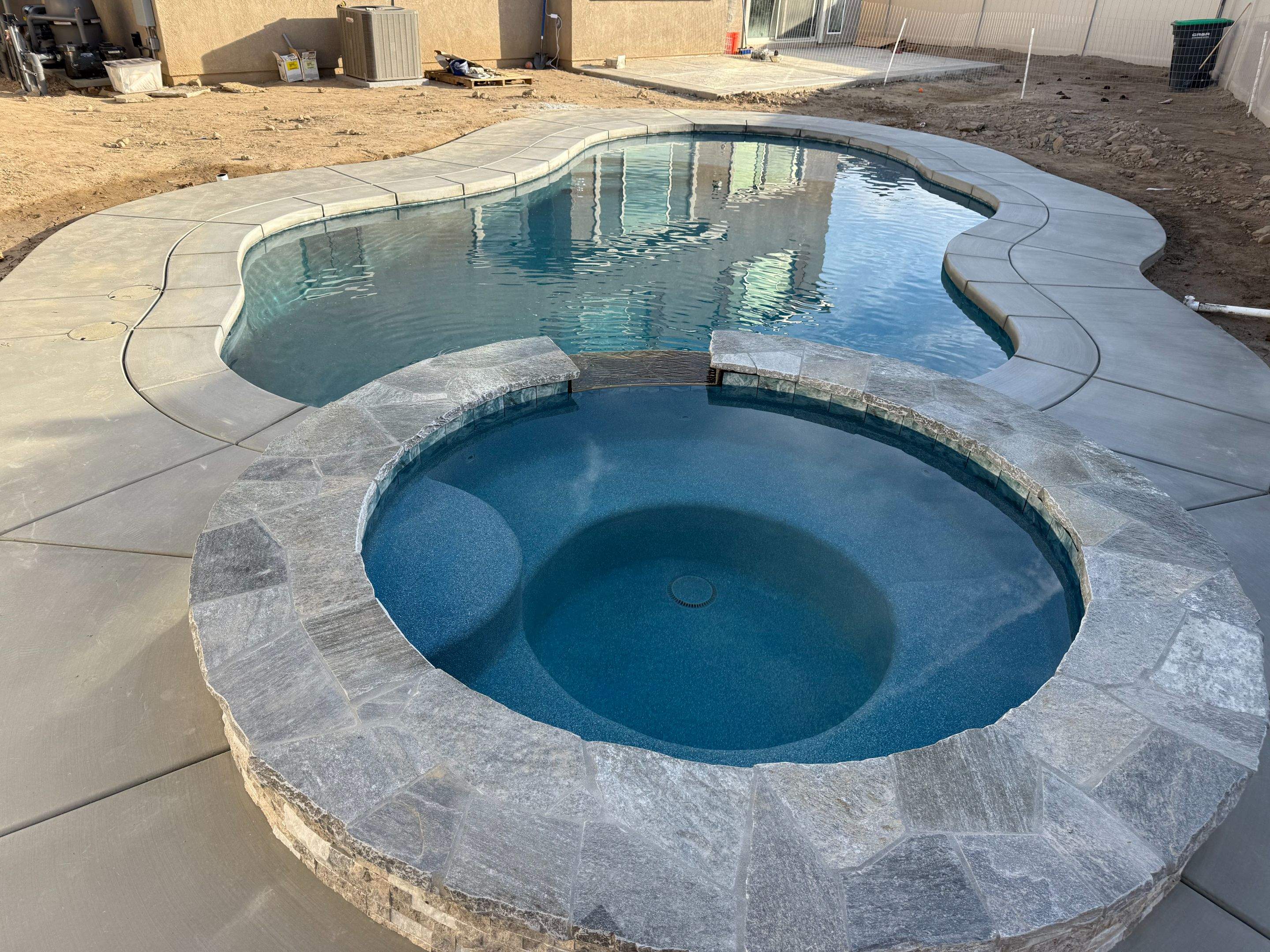 Freeform pool and spa, quartz stone coping on spa, pip on pool by Premier Pools and Spas Temecula