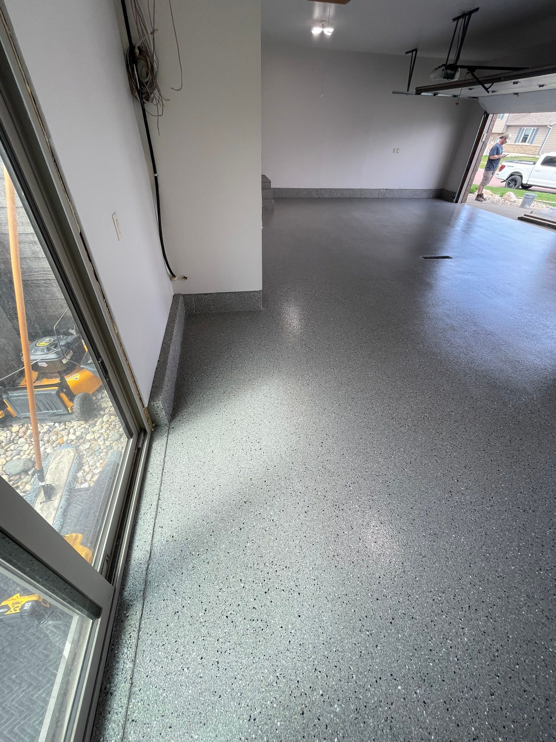 Residential Garage Floor Coating with Grey Speckled Epoxy Finish by Select Painting, Coatings & Garage Cabinets