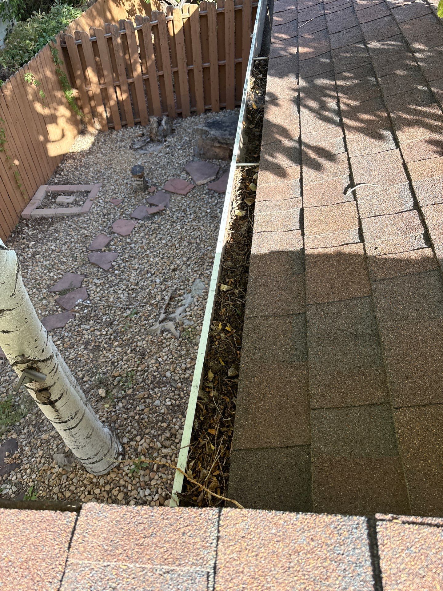 Commercial gutter cleaning Pueblo before photo with filled gutters