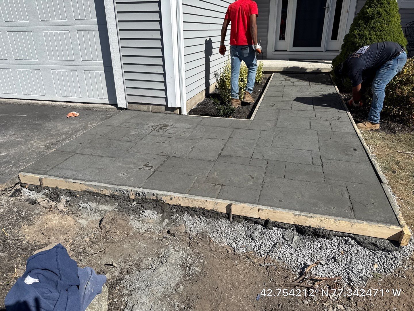 Stamped English Rivenstone concrete patio and sidewalks  by NG Masonry & Construction LLC
