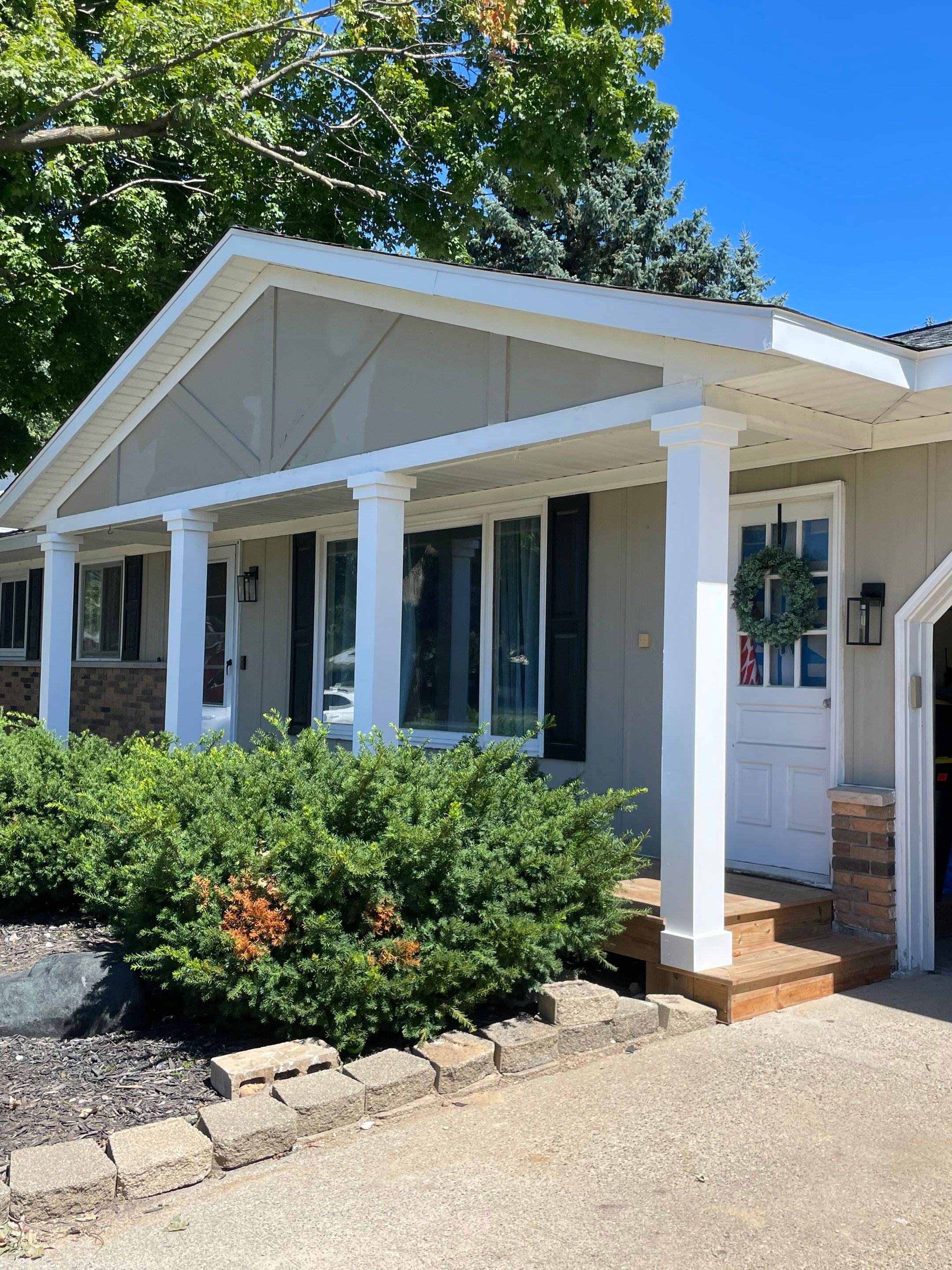 Front Porch Posts and Treated Porch Floor and Steps by Avalon Roofing and Exteriors