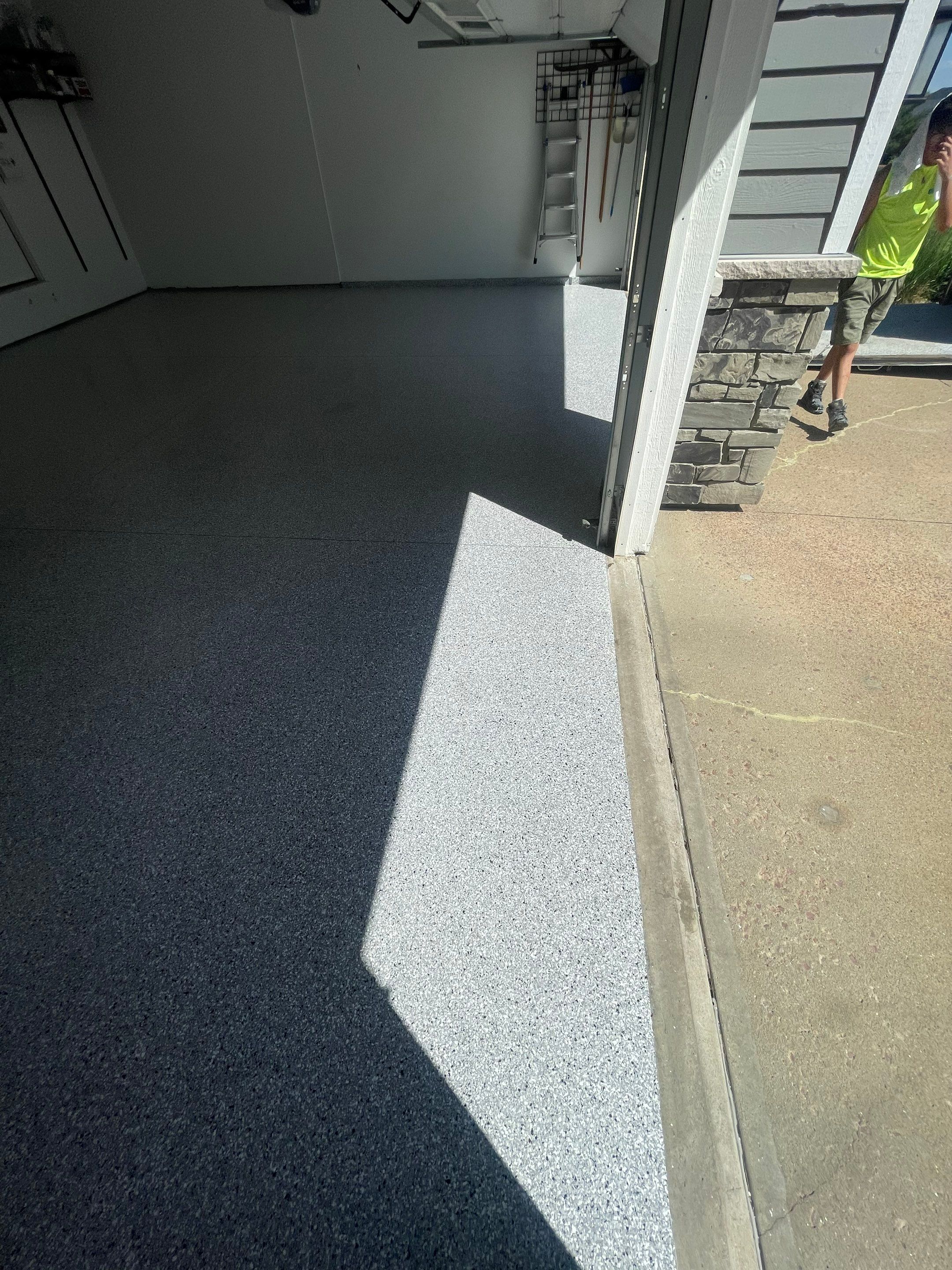 Feather Grey Garage Floor Coating Installation in Sioux Falls by Select Painting, Coatings & Garage Cabinets