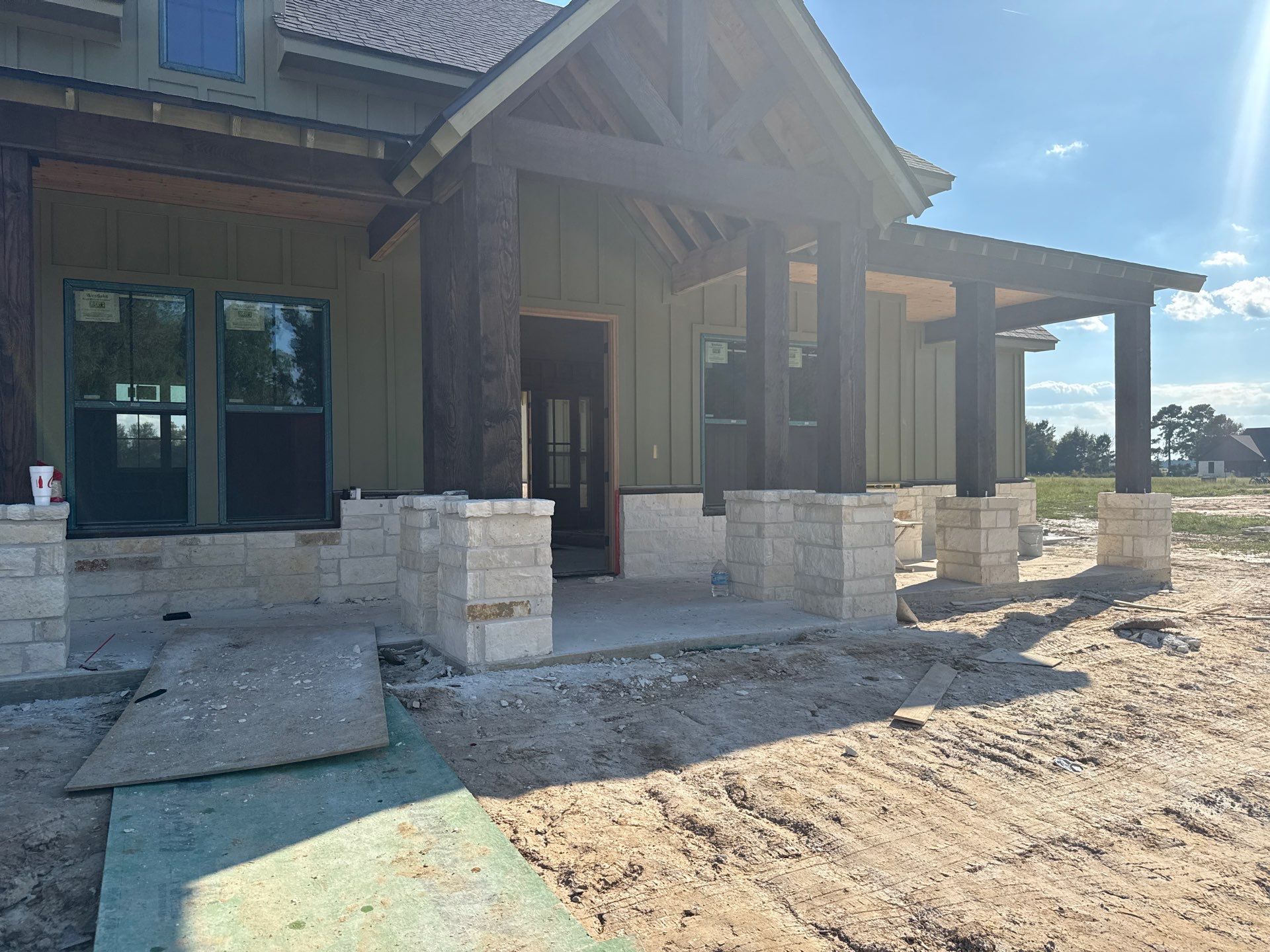 Cleveland Ranch Charm: Natural Stone Wainscot with Green Accent Siding. by Apex Conventional Stucco Llc