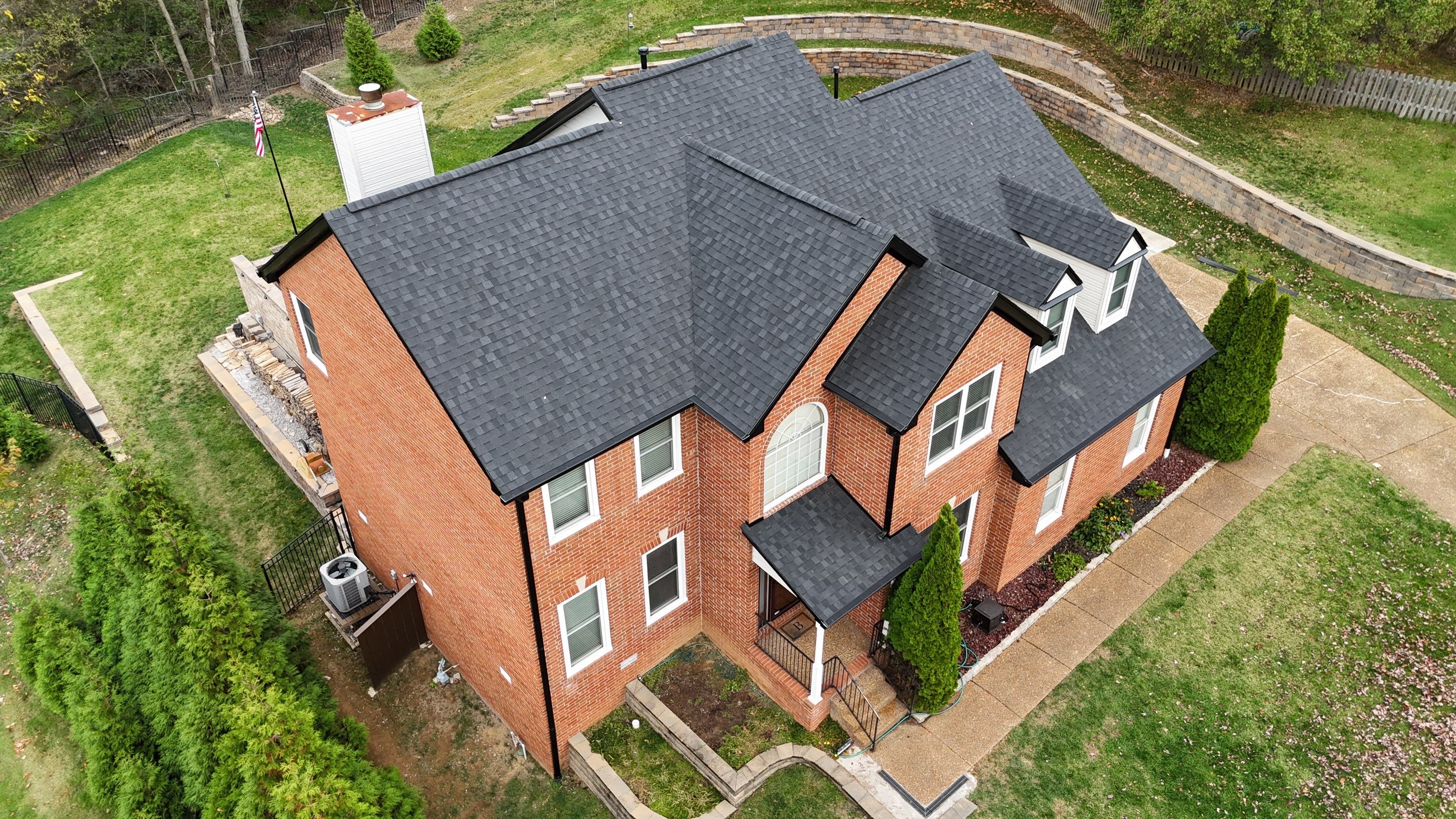 Charcoal Black Re-Roof & Gutters by Royal House LLC