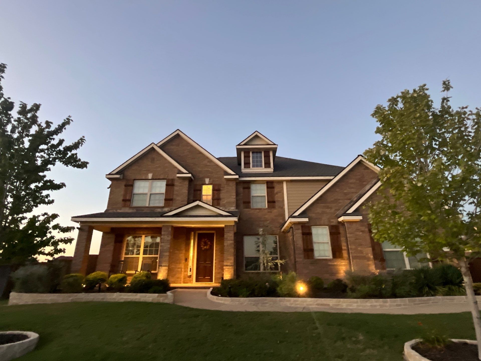 Medium brown brick with GAF Pewter Gray  by Tejas Roofworks + Restoration