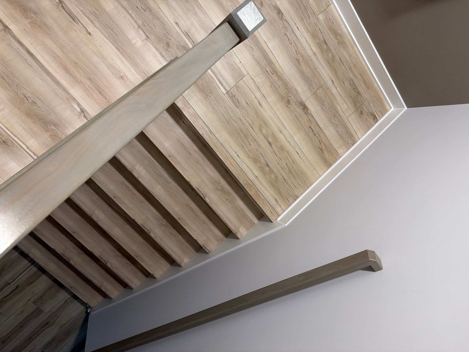 Fishers Staircase Renovation Featuring Custom Herringbone Runner and Modern Railing by Brothers Floor Covering INC.