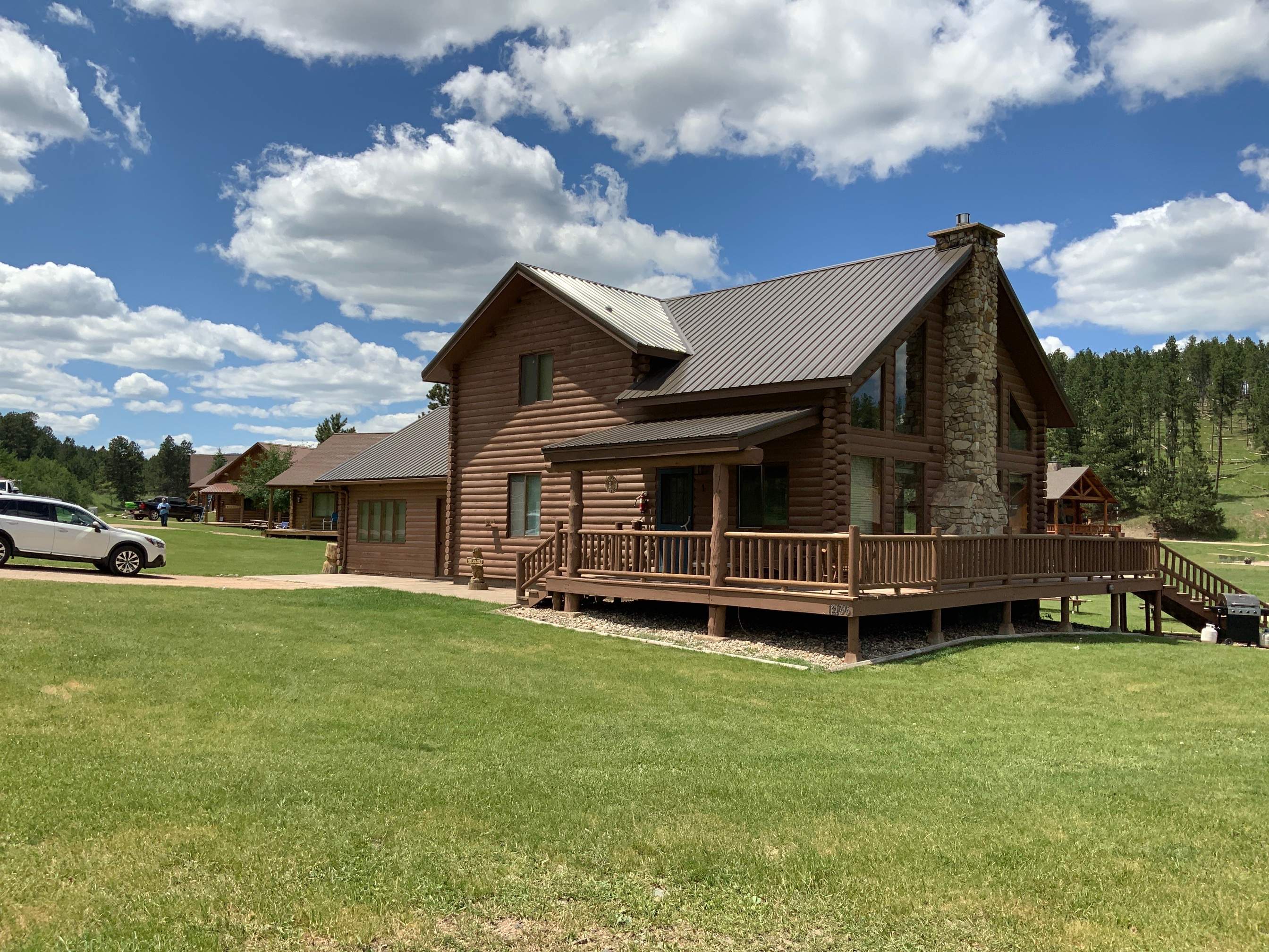 Hill Country Guest Ranch using Steel Roofing, Gutters, Log Cabin Staining by Lightning Exteriors