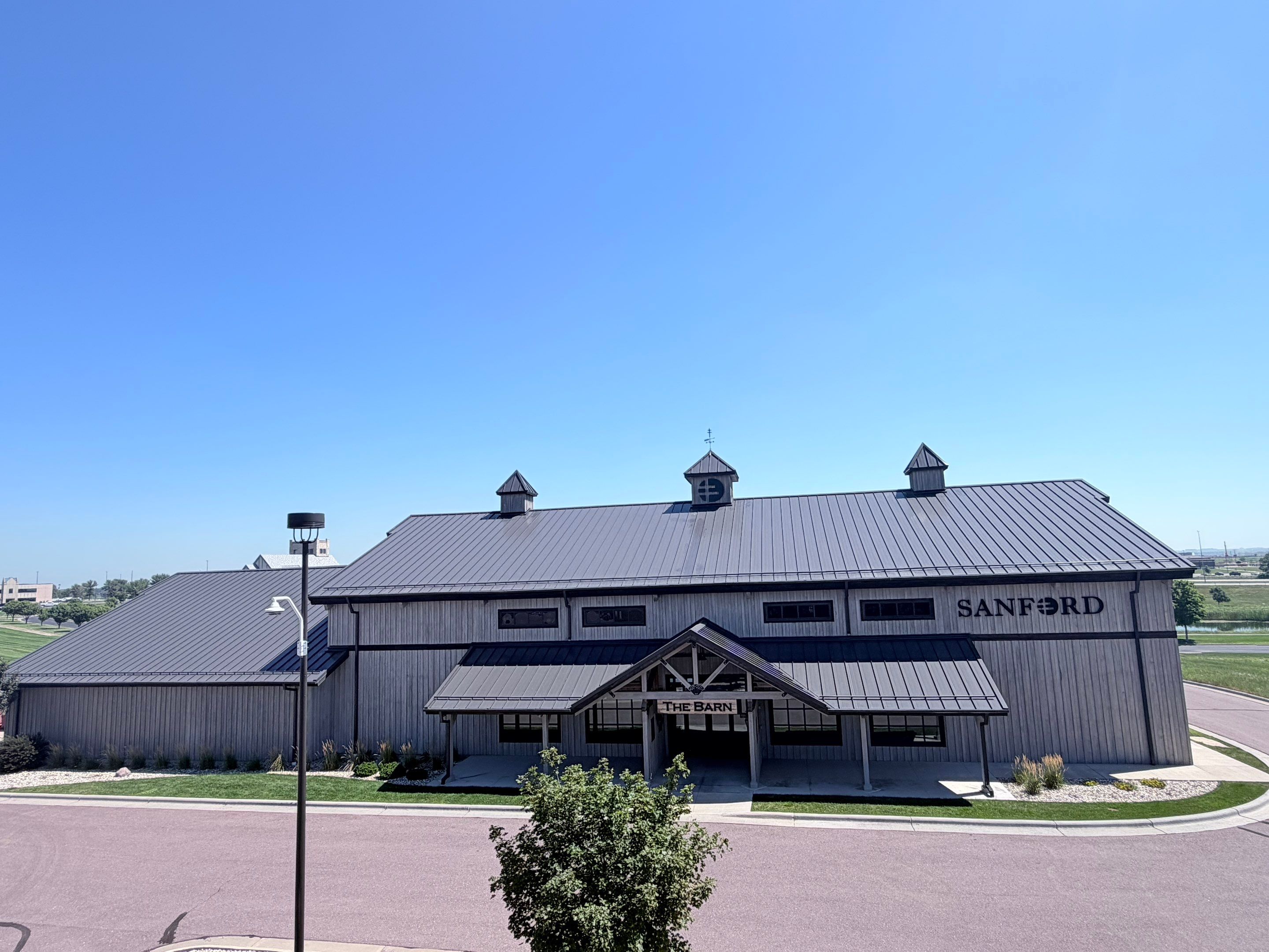Commercial Exterior Wood Staining for Sanford Barn in Sioux Falls by Select Painting, Coatings & Garage Cabinets