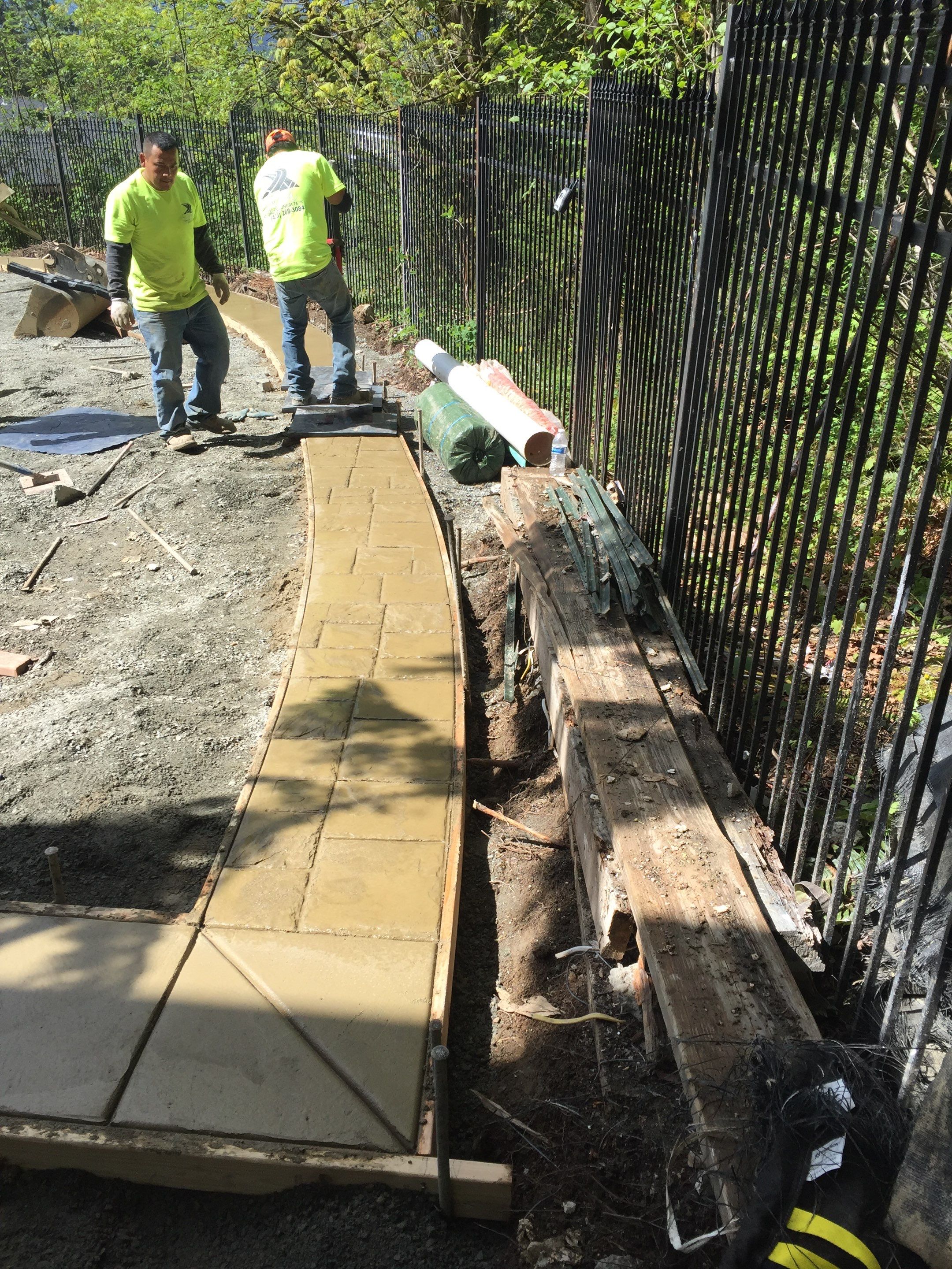 Asphalt Driveway and Stamped Concrete Patio Finish  by Jireh Asphalt & Concrete Inc 