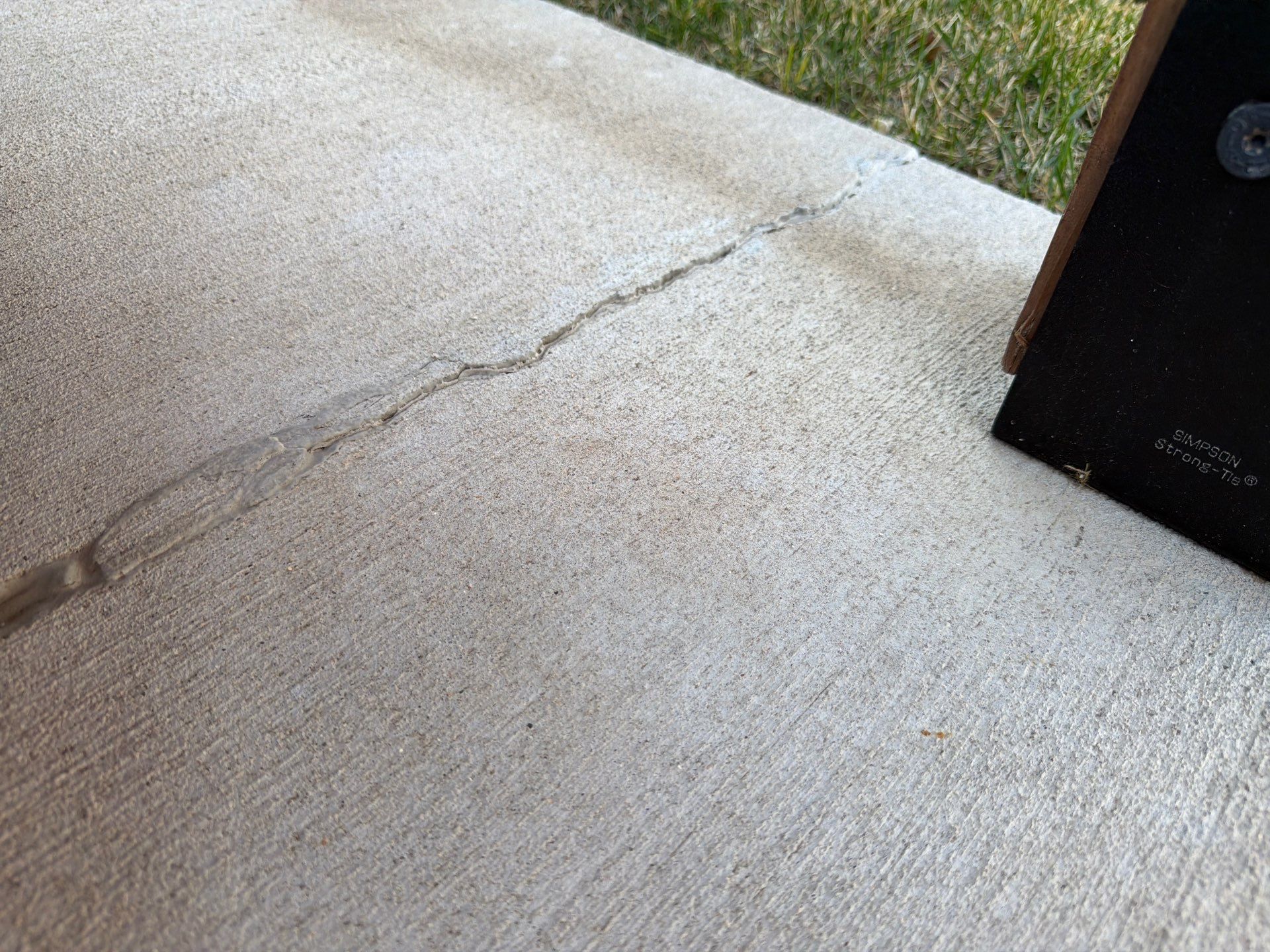 Textured Concrete Patio Coating and Custom Privacy Pergola in Sioux Falls by Select Painting, Coatings & Garage Cabinets