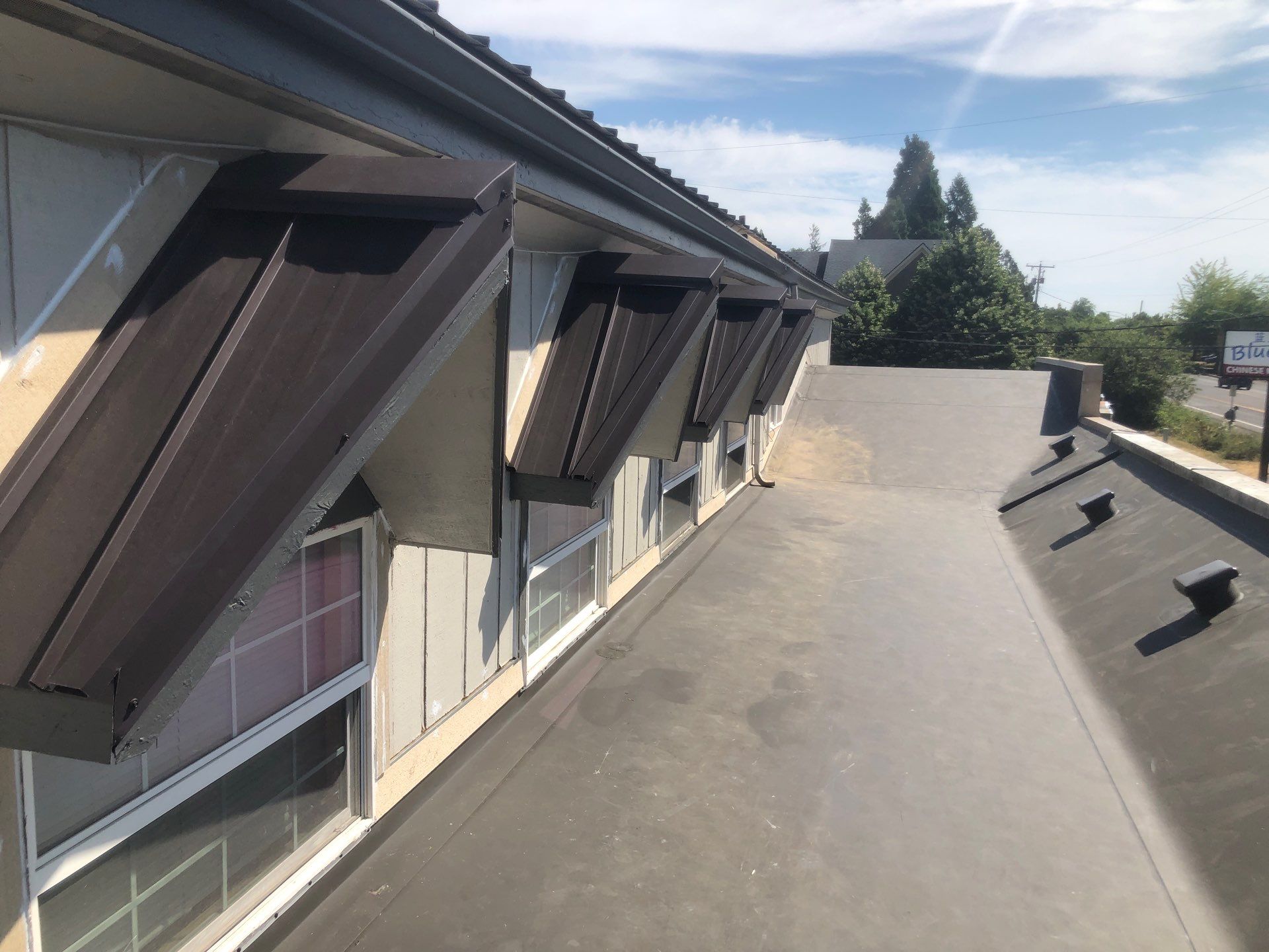 Commercial Flat Roof Installation using Bruce and Dana Snap Lock Metal (Color: Brown) by Orezona Building & Roofing Company, Inc.