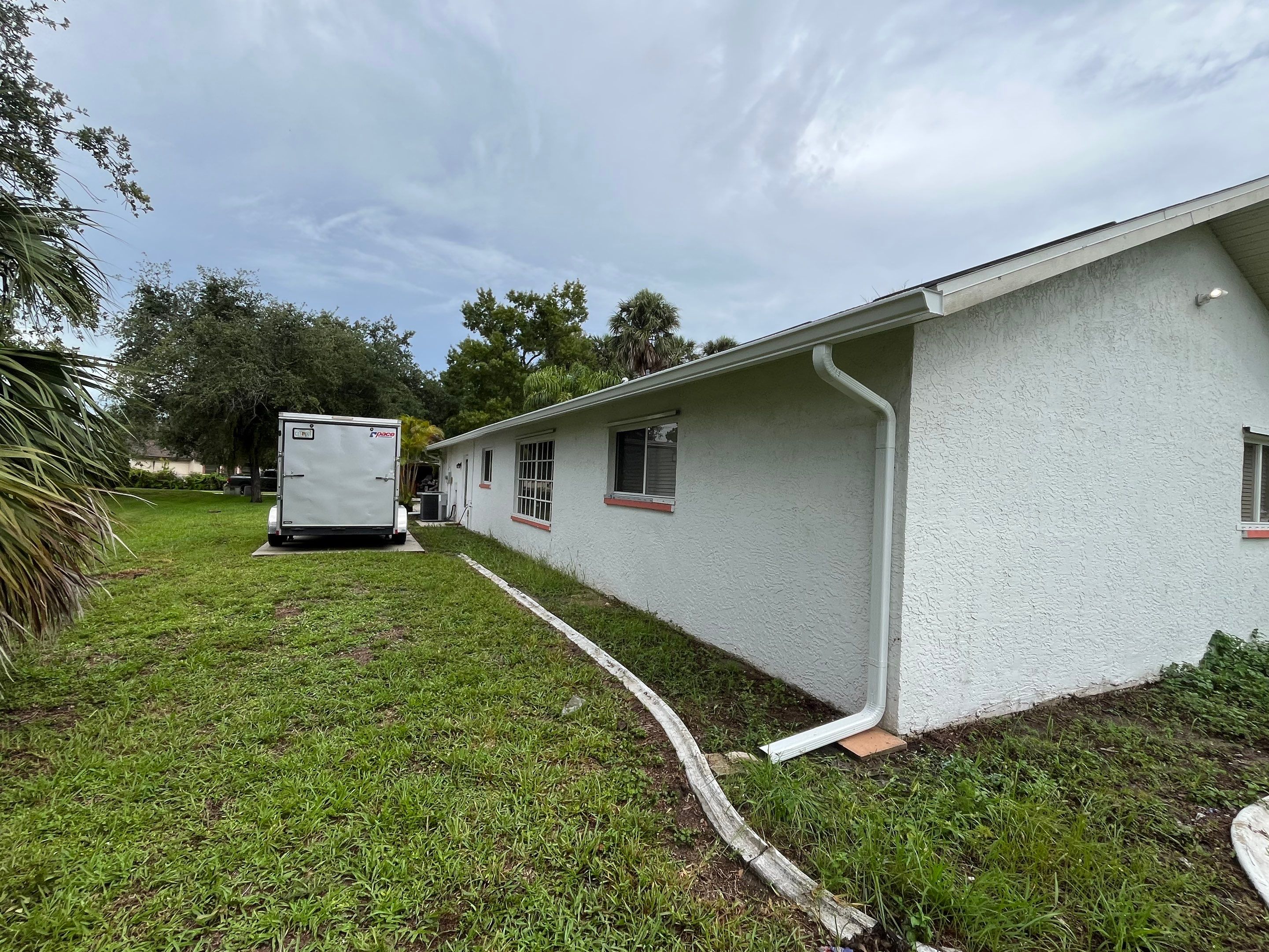 White Seamless Gutters with Splash Guards in North Fort Myers FL by Gutter Professor   by Gutter Professors