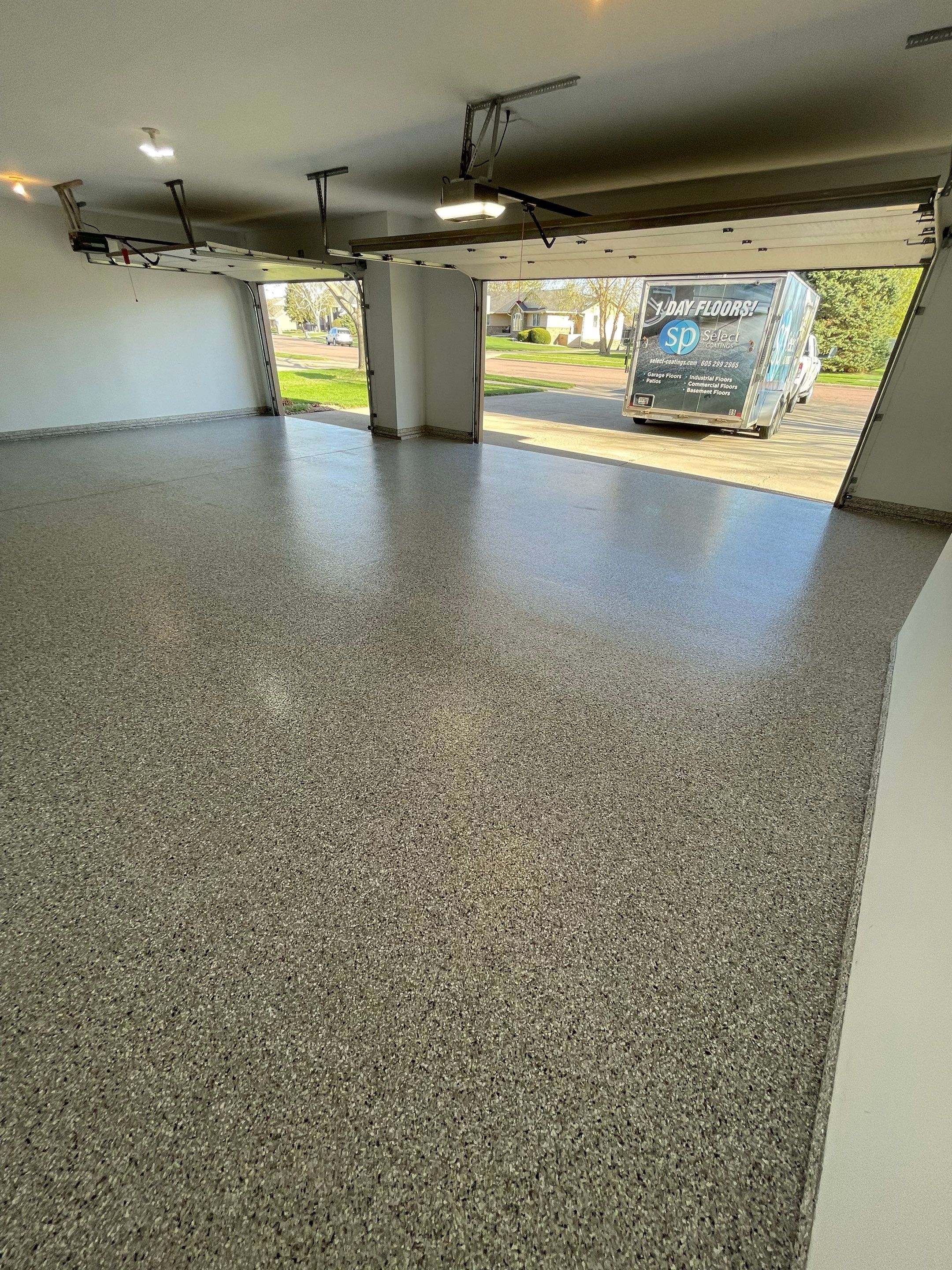 Yankton Garage Floor Restoration with Gray Speckled Epoxy Coating by Select Painting, Coatings & Garage Cabinets