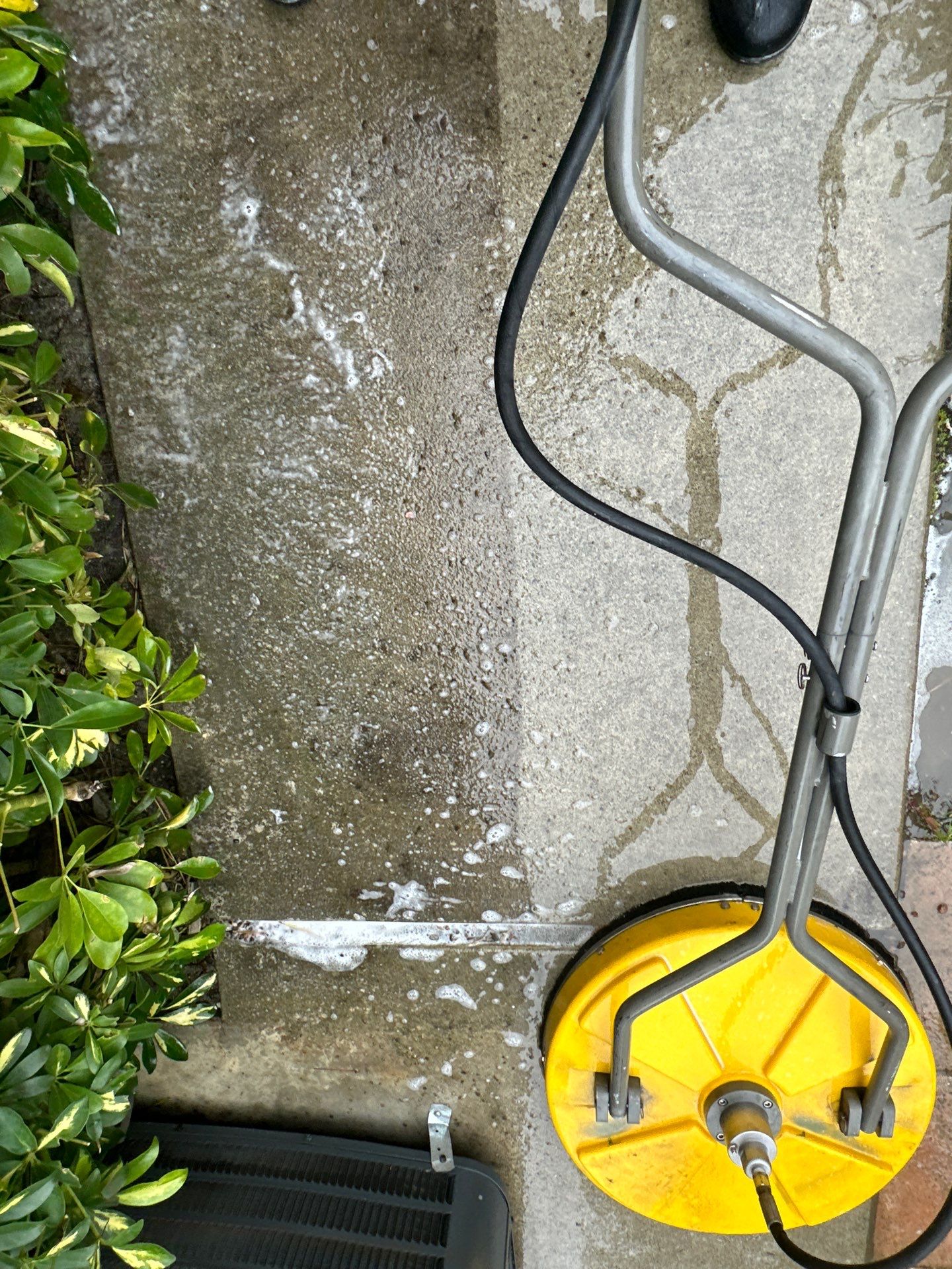 Driveway, patio, and rear entry walkway pressure washing in Orange County by Property Cleaning Experts