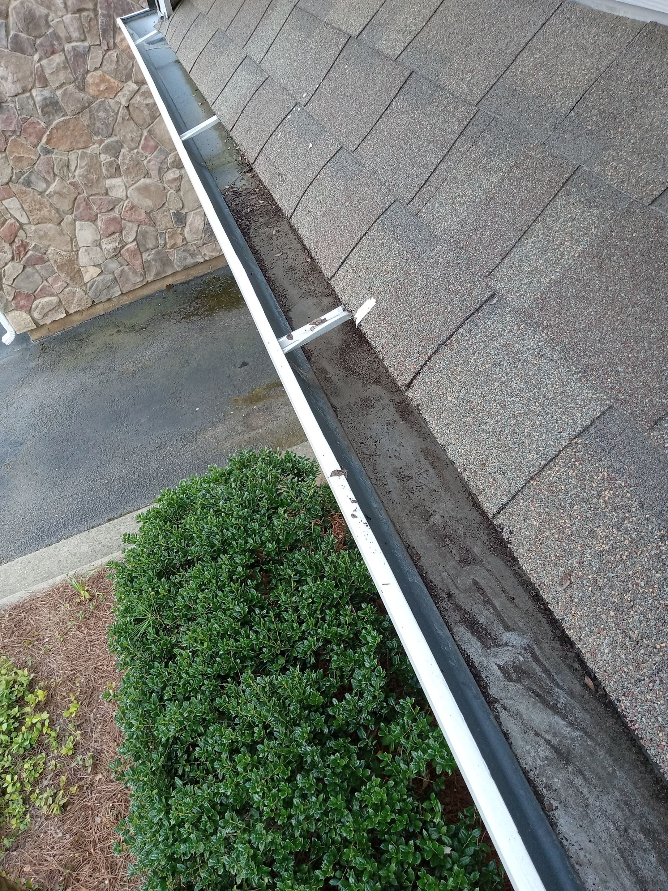 HOA gutter cleaning in Cumming & Forsyth County, GA, after  photo showing full gutters.