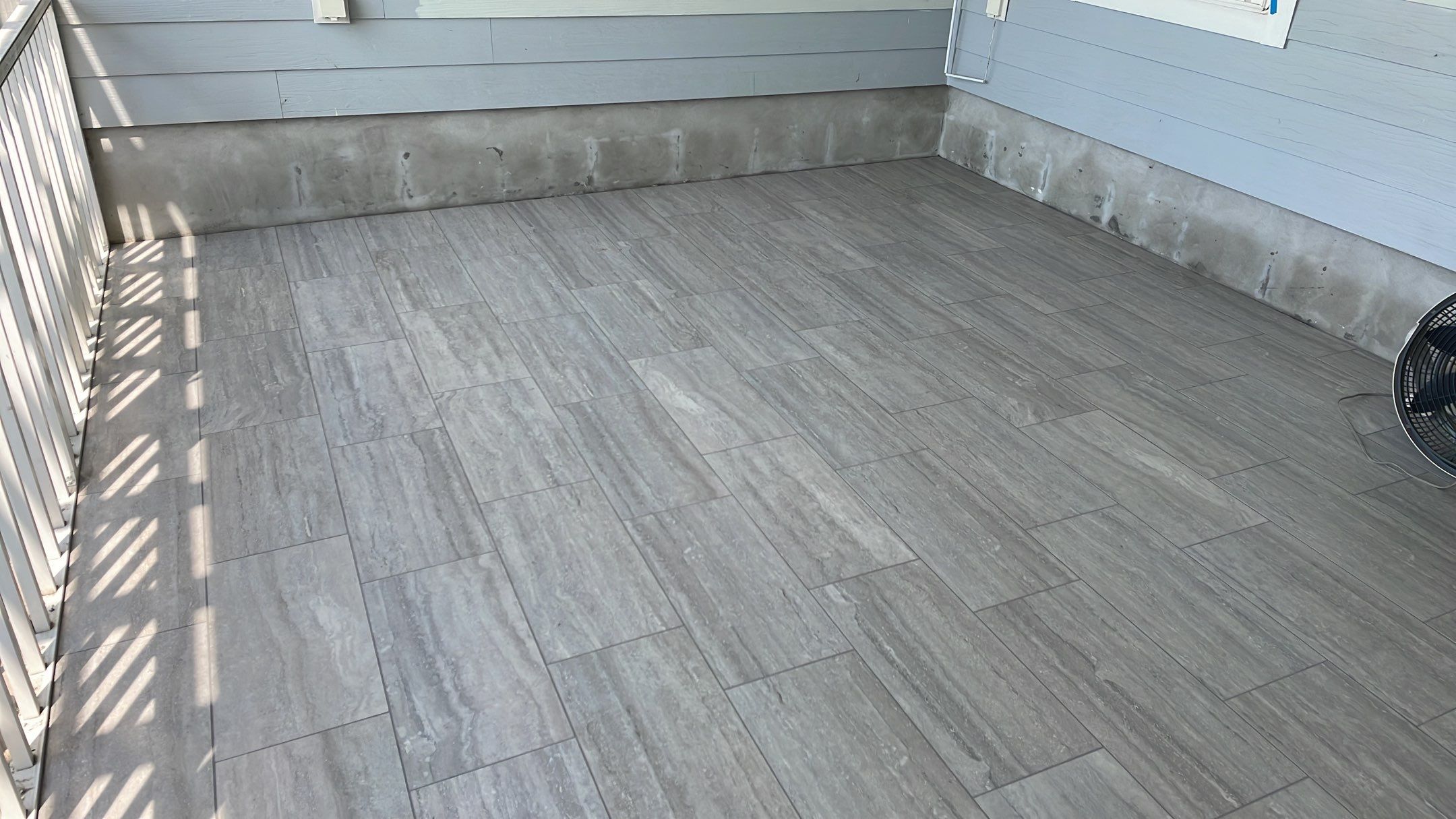 Sunroom using 12x24 tiles by Footprints Floors of Coastal Carolina