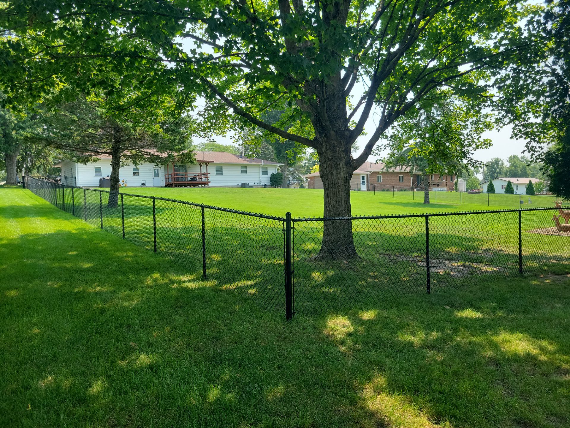 Black Vinyl-Coated Chain Link Fence Installation in New Hampton by Perfect Picket Fence and Stain