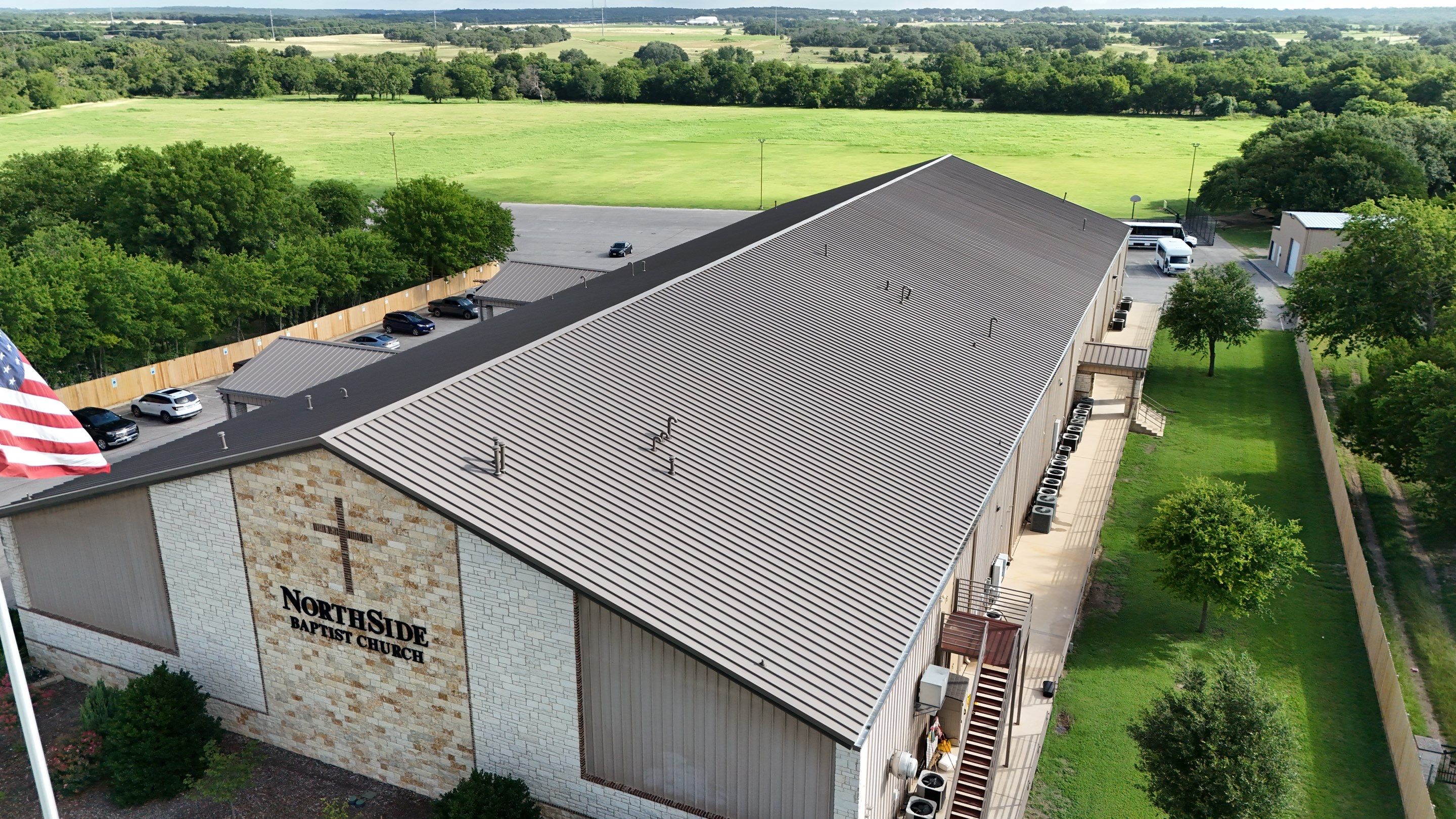 Commercial Roofing Installation using 24 GA 2" Seam Metal Retrofin - Buckskin by Action Exteriors Austin