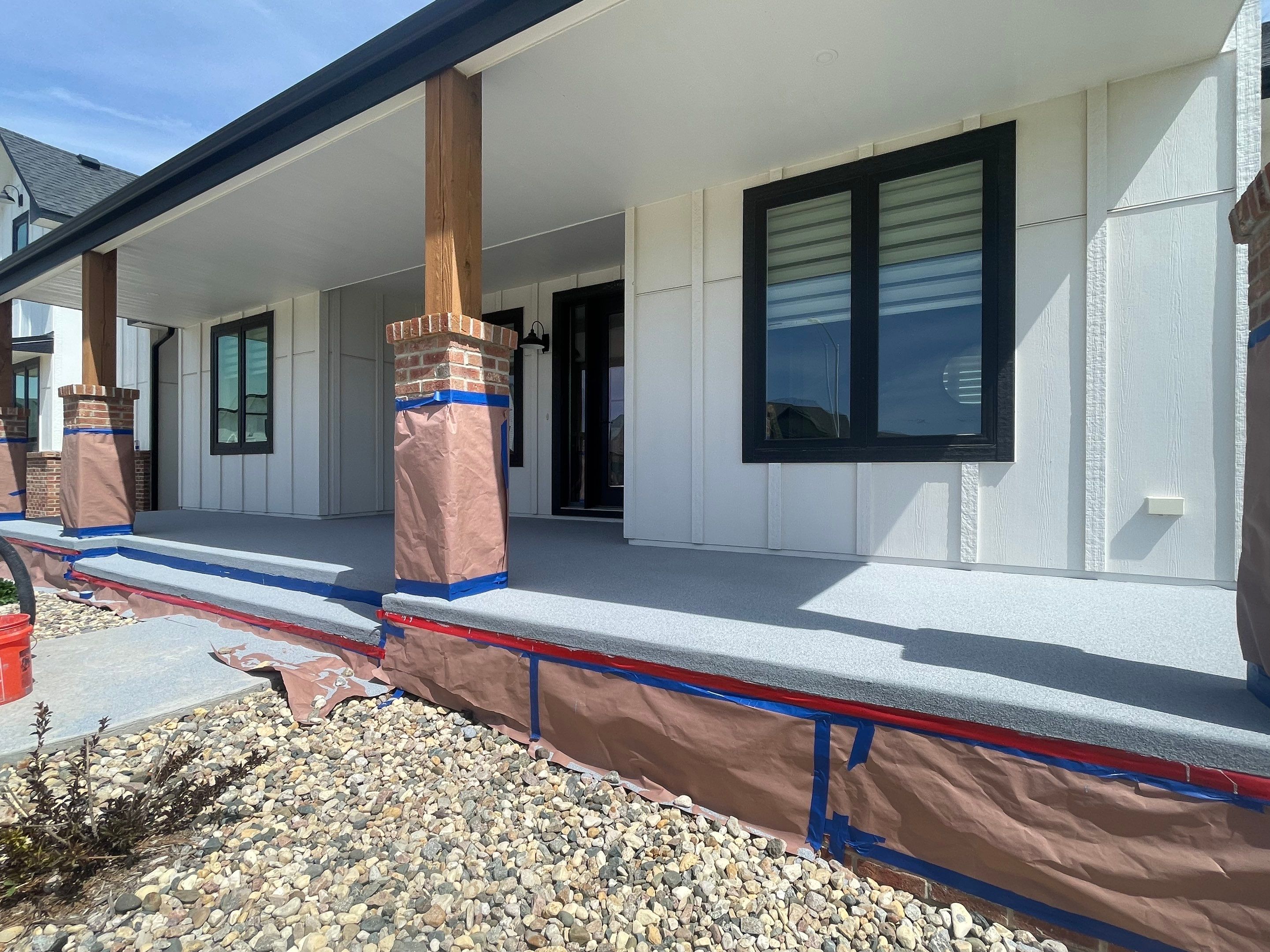 Grey Speckled Concrete Porch Coating for Sioux Falls Home by Select Painting, Coatings & Garage Cabinets