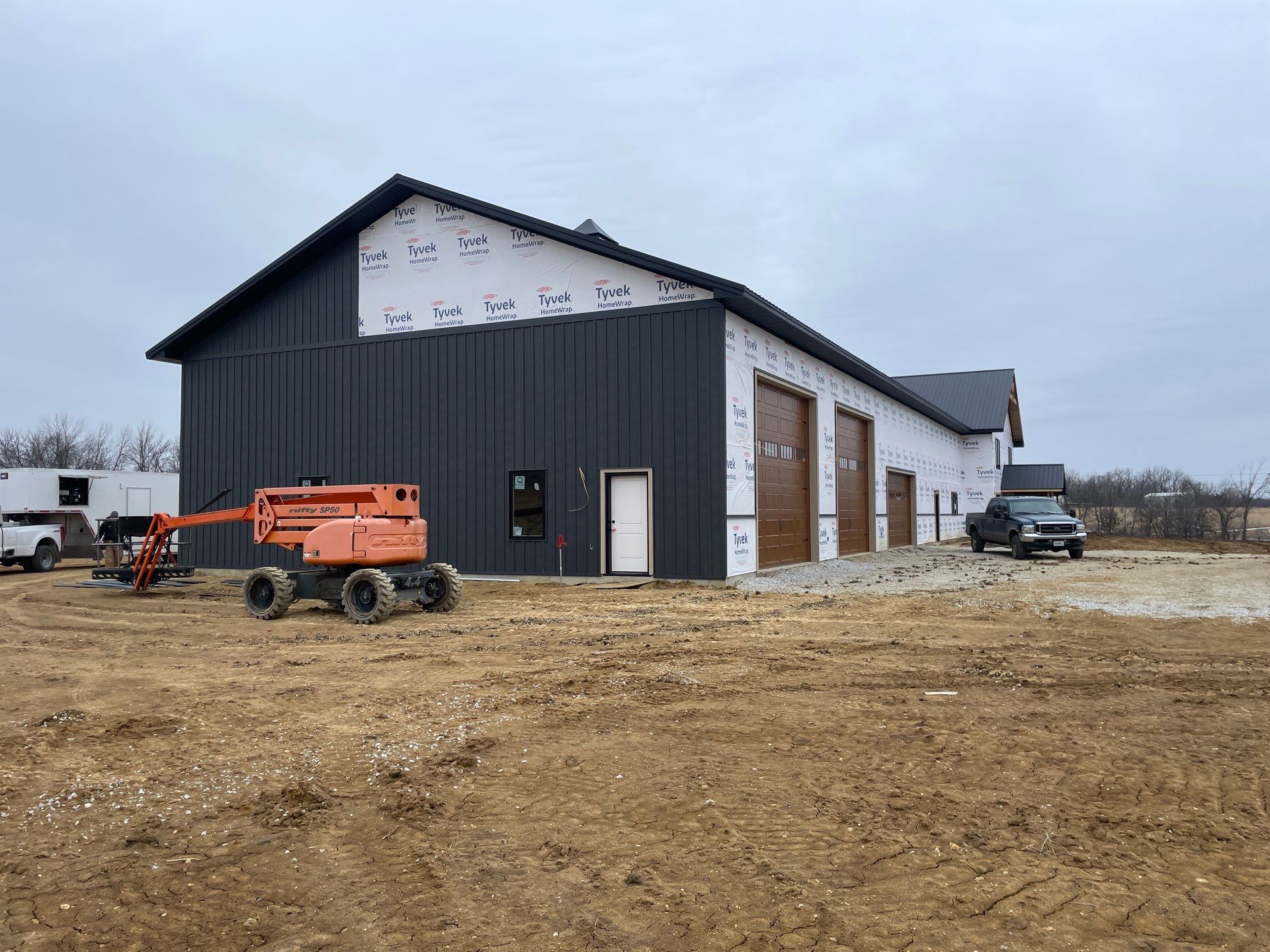 New Home construction w/ board and batten sides and metal roof  by Miles Construction 