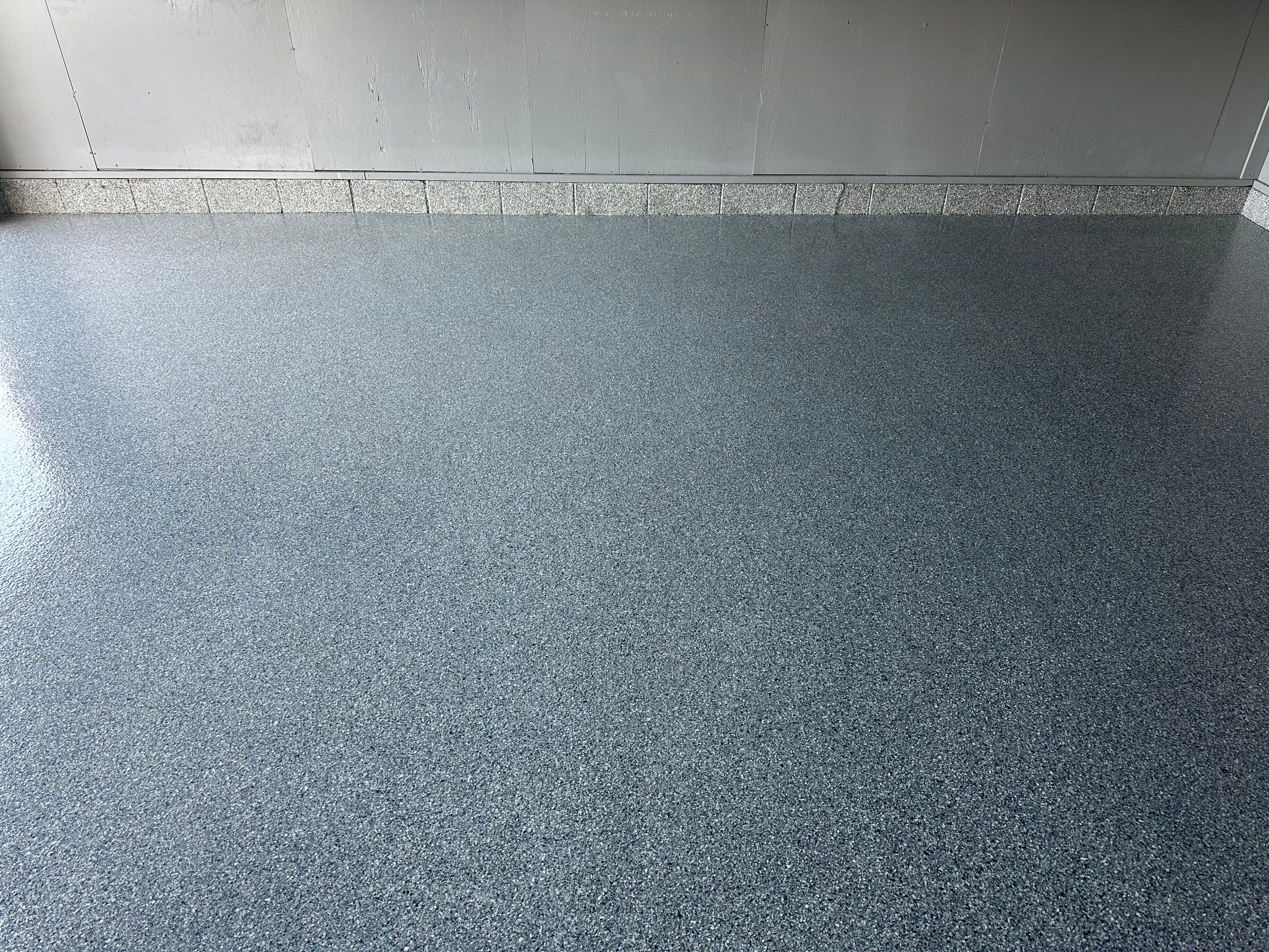 Multi-Colored Speckled Concrete Floor Coating Installation in Sioux Falls by Select Painting, Coatings & Garage Cabinets