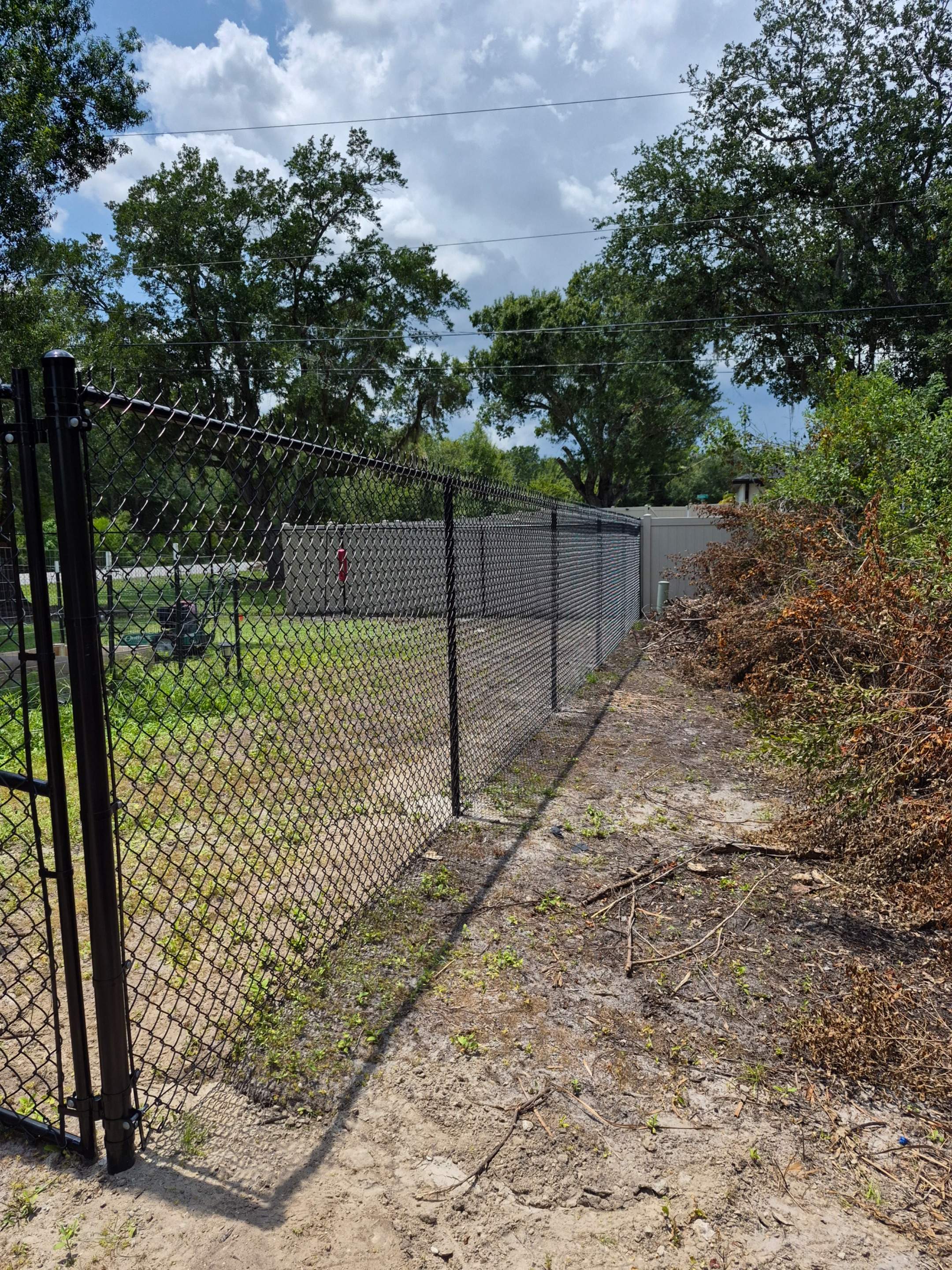 Black Chain Link Perimeter Fencing with Double Gates in Port Charlotte by True Fence LLC