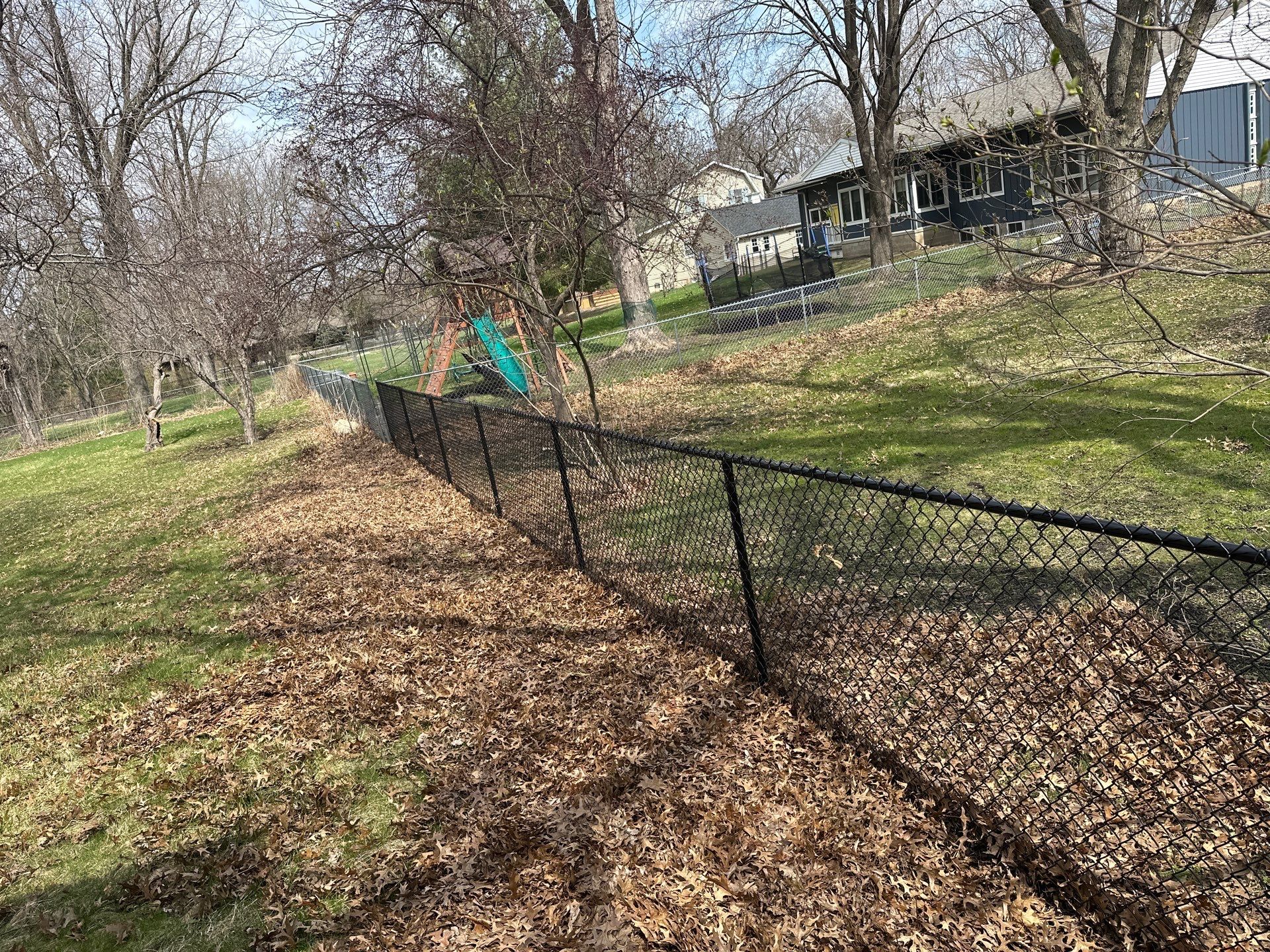 Black Vinyl-Coated Chain Link Fence Installation in Cedar Falls by Perfect Picket Fence and Stain