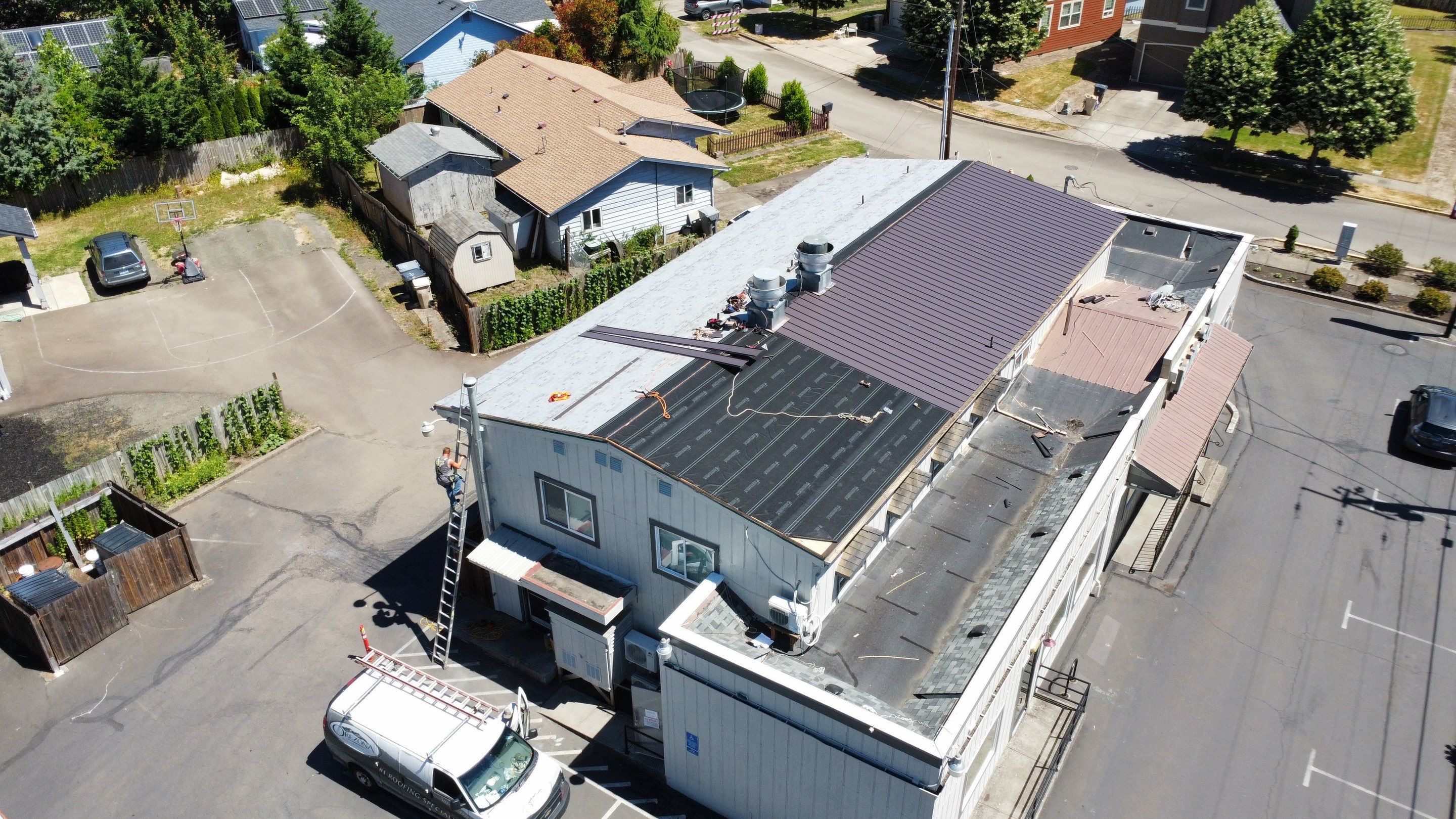 Commercial Flat Roof Installation using Bruce and Dana Snap Lock Metal (Color: Brown) by Orezona Building & Roofing Company, Inc.