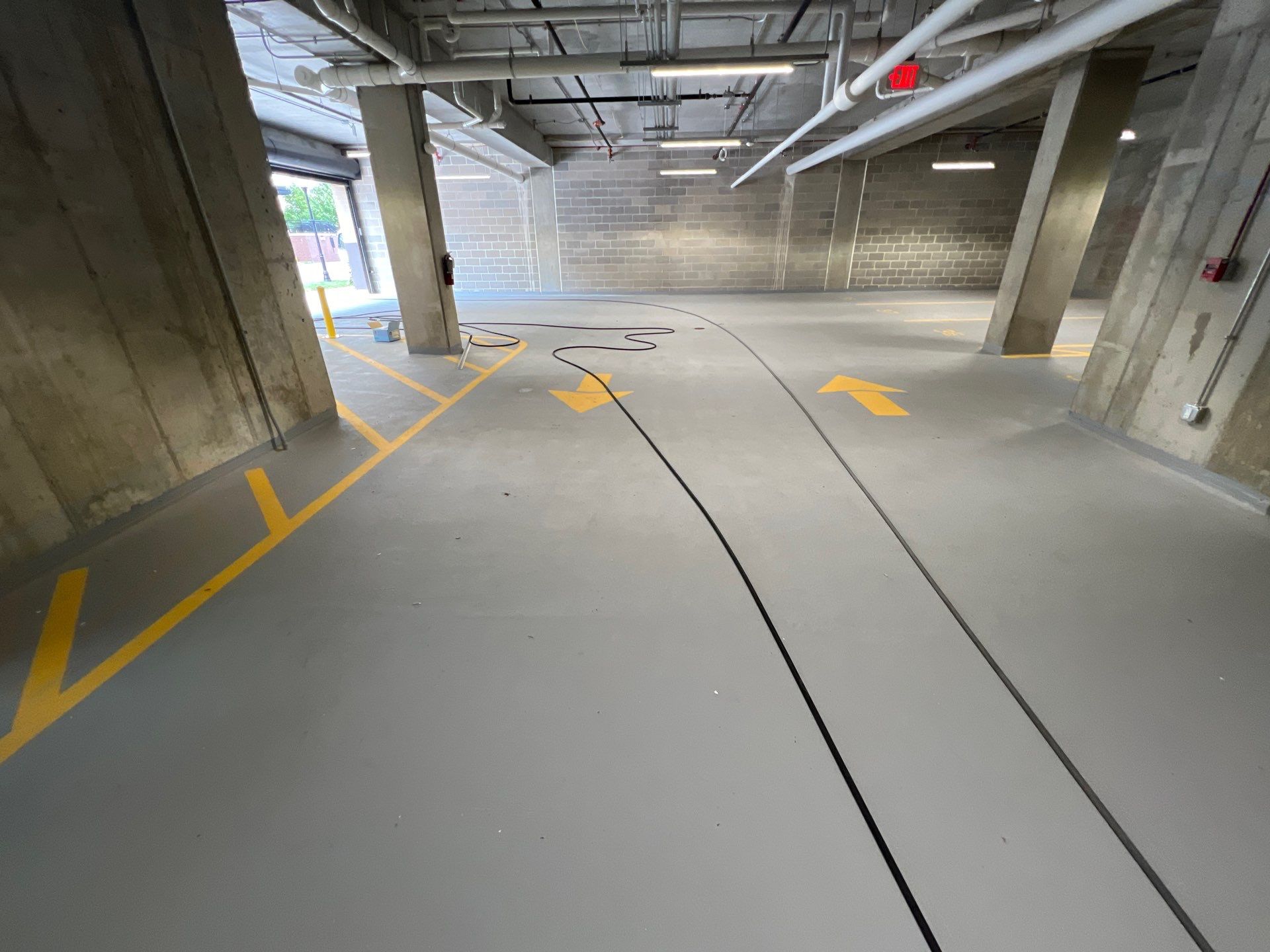 Parking garage using Hot water by Northern Power Washing LLC.