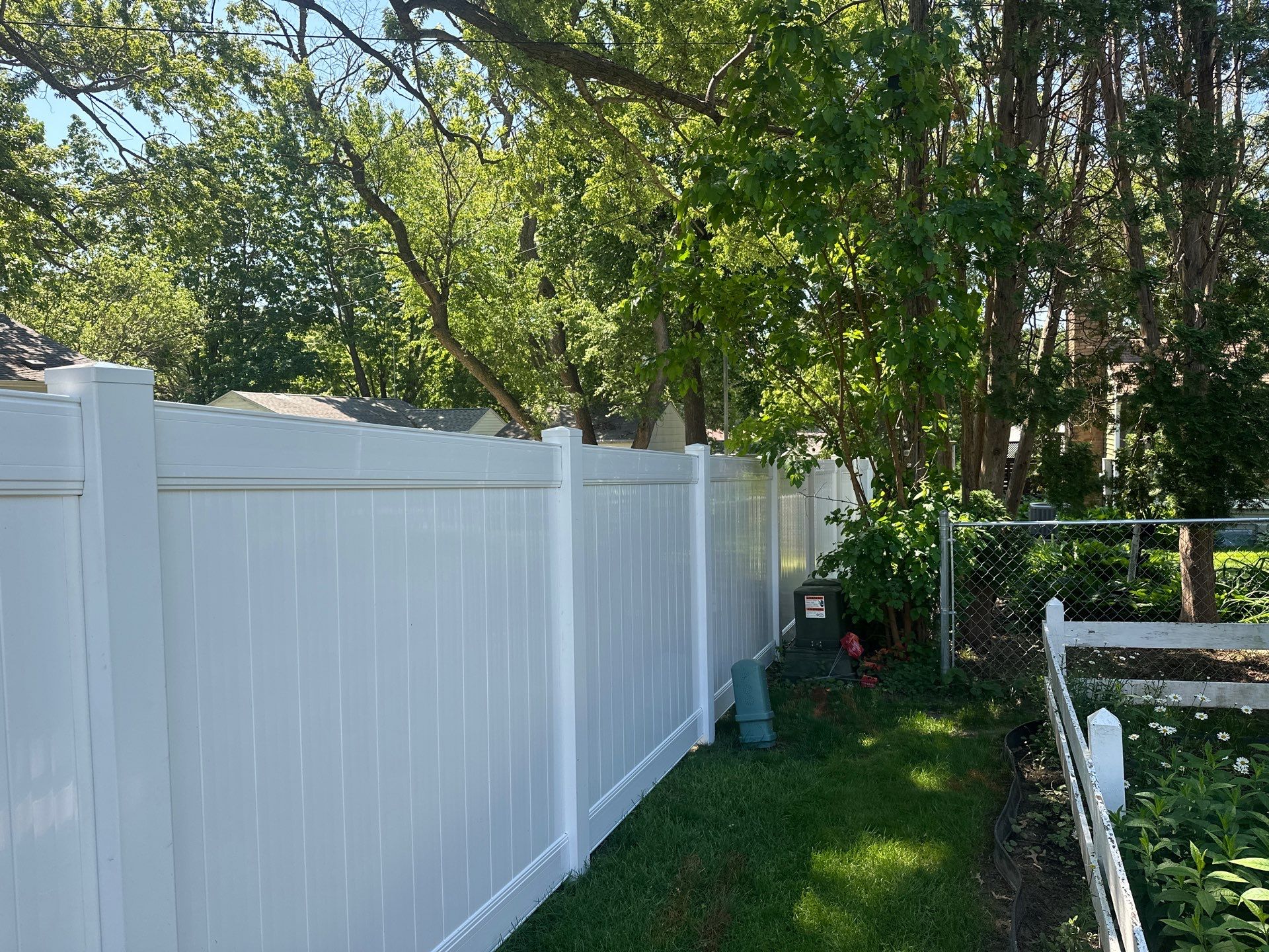White Vinyl Privacy Fence and Double Gate Installation in Cedar Falls by Perfect Picket Fence and Stain