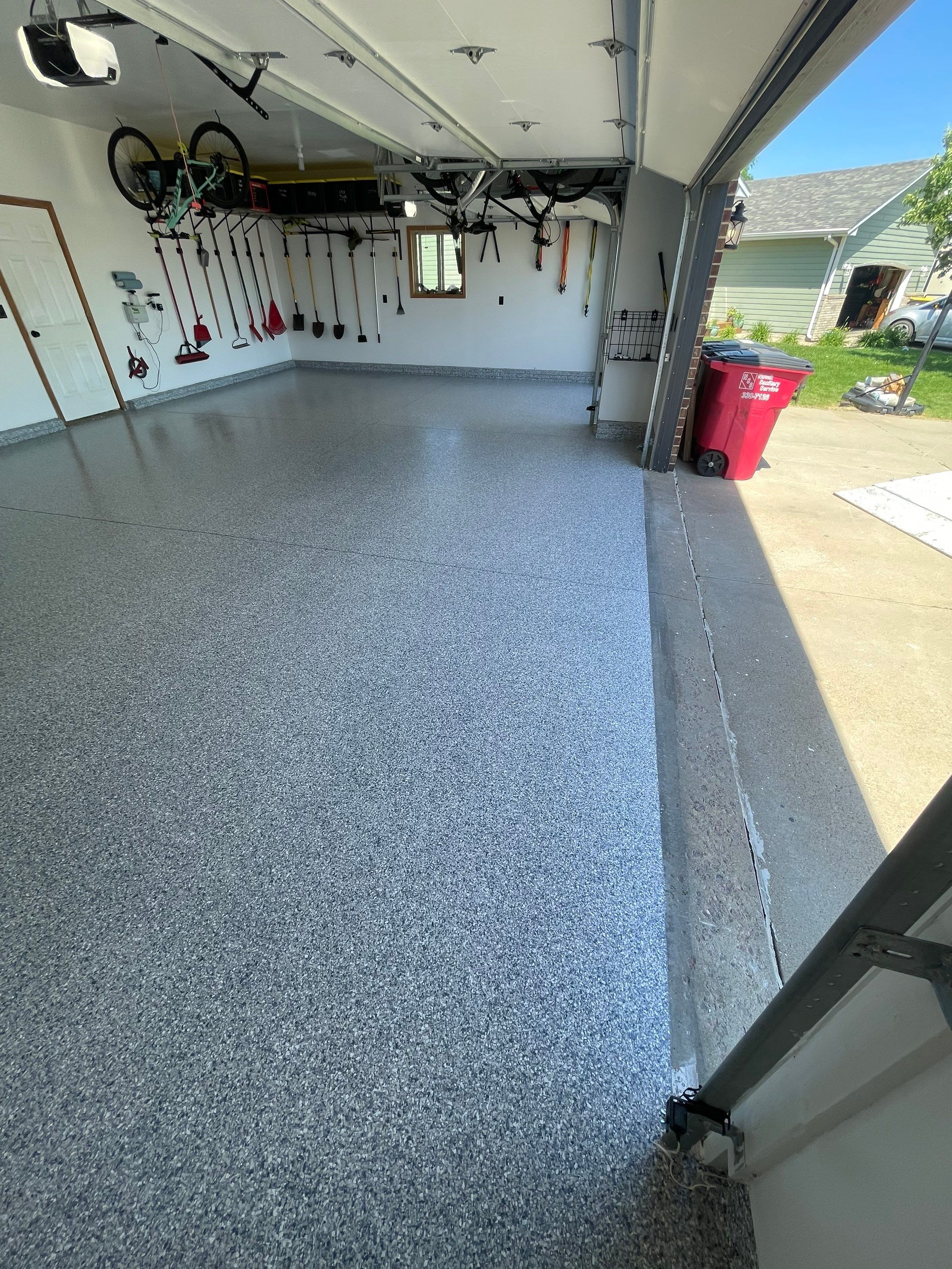 Tidal Wave Flake Garage Floor Installation in Sioux Falls by Select Painting, Coatings & Garage Cabinets