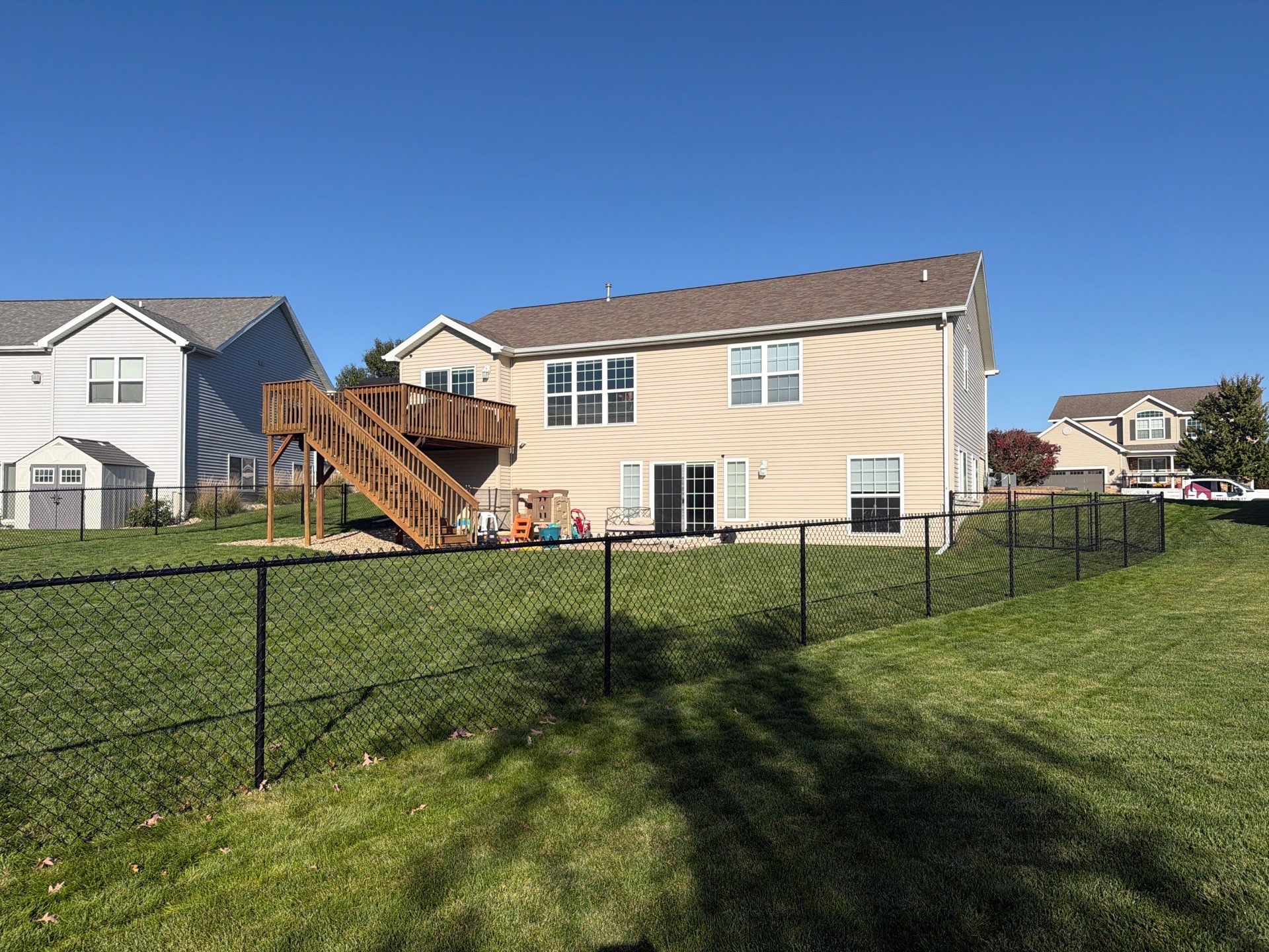 Black Vinyl-Coated Chain Link Fence Installation in Cedar Falls by Perfect Picket Fence and Stain