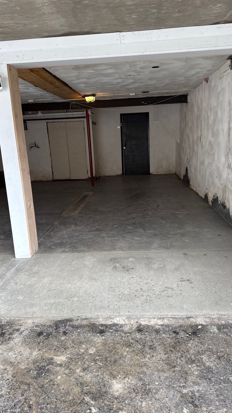 Concrete garage floor replacement with a broom finished apron and wall repair by NG Masonry & Construction LLC