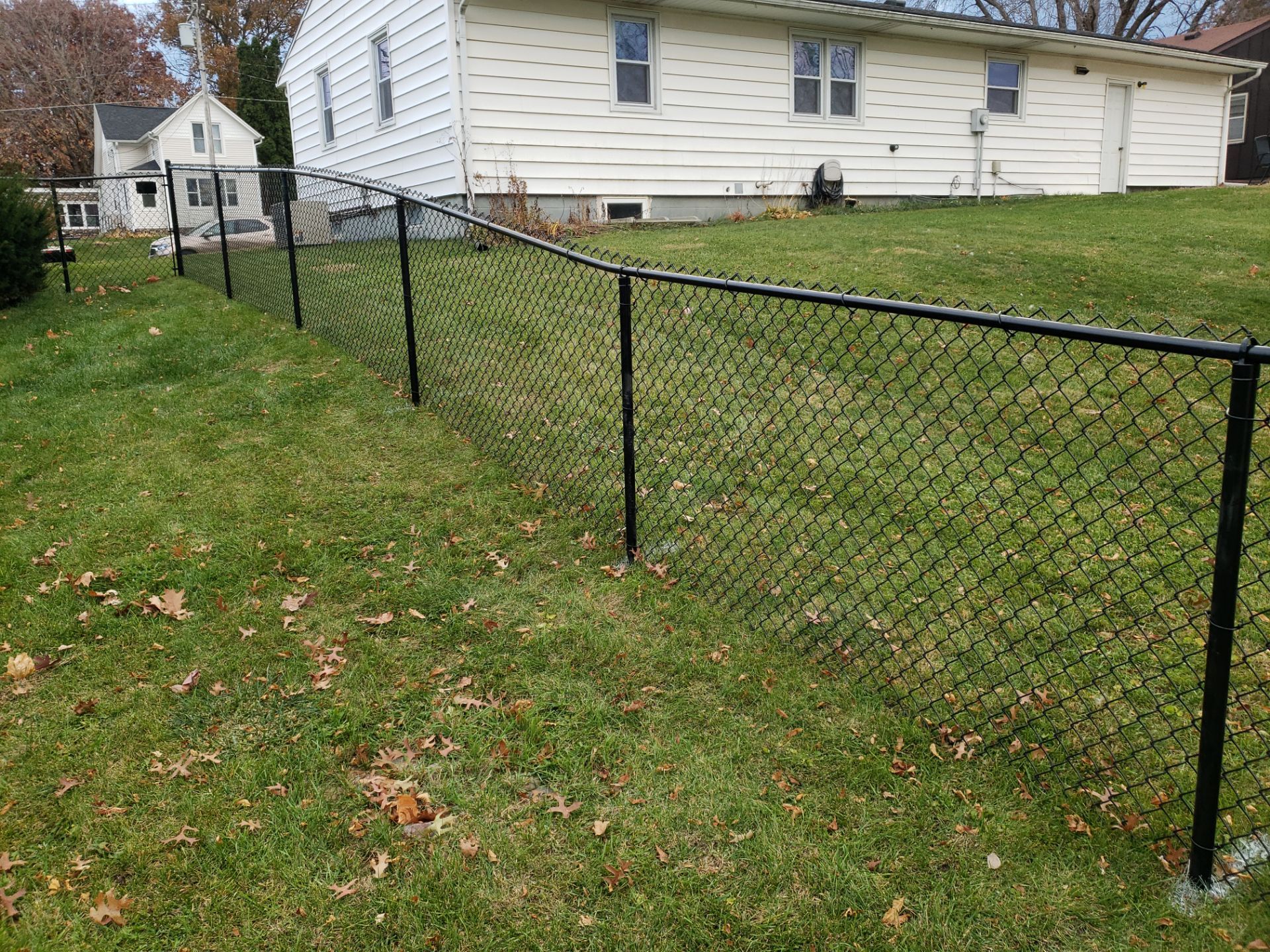 Residential Black Vinyl-Coated Chain Link Fence in Grundy Center by Perfect Picket Fence and Stain