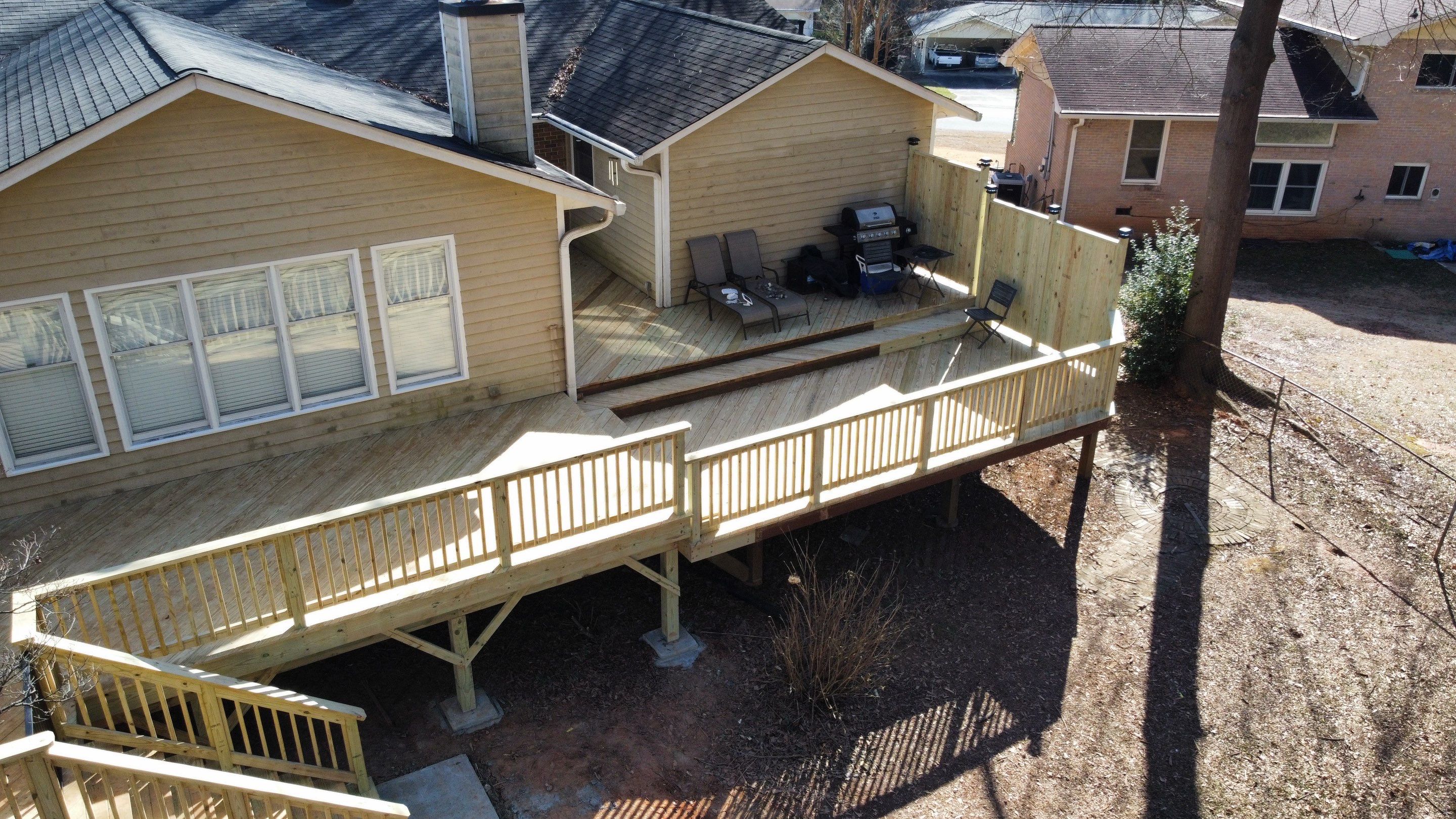 Elevated Pressure-Treated Wood Deck Extension in Marietta by Swift Home Renovations