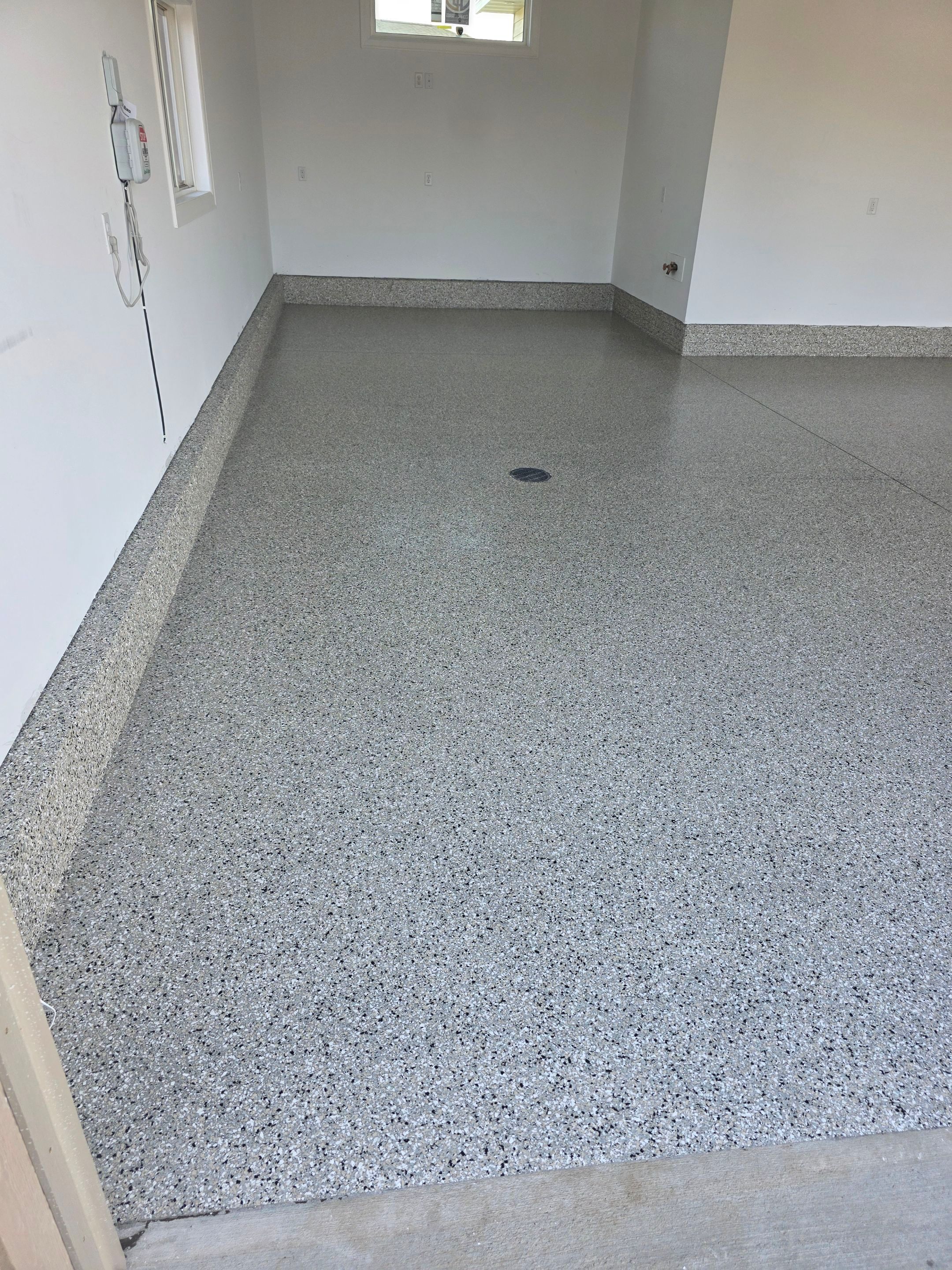 Gray and Black Speckled Polyurea Garage Floor in Dell Rapids by Select Painting, Coatings & Garage Cabinets