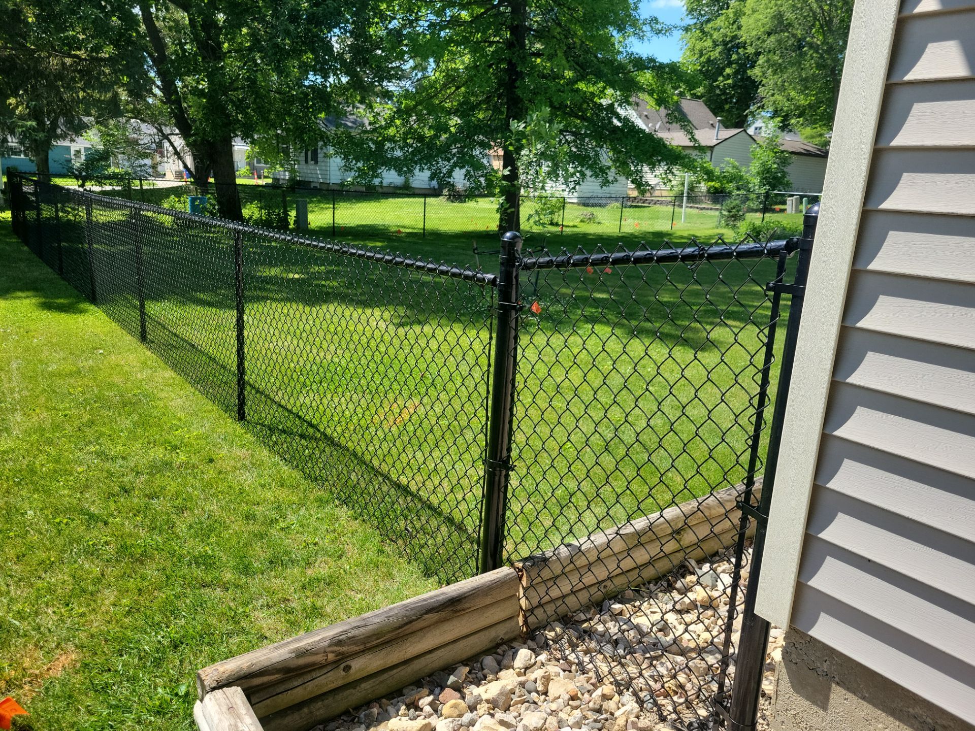 Black Chain Link Perimeter Fence and Driveway Gate in Waverly by Perfect Picket Fence and Stain