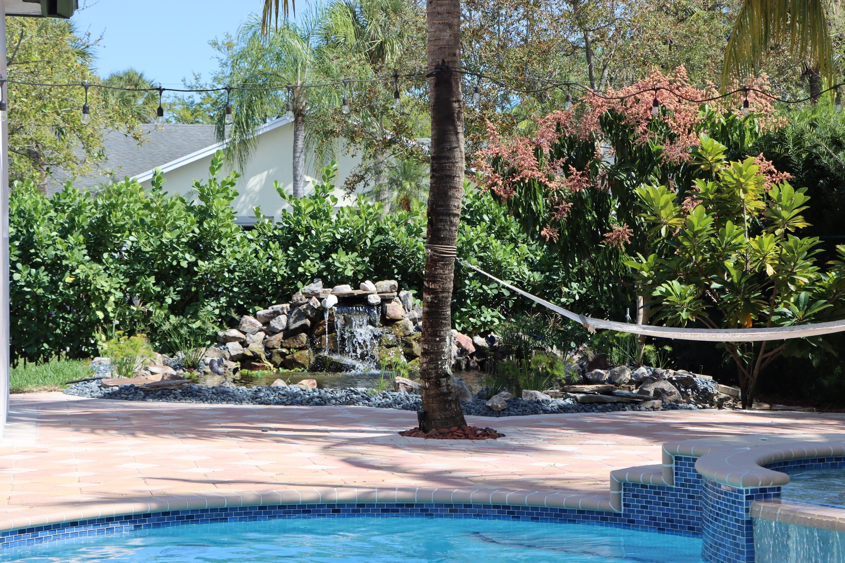 Gorgeous Koi Pond in Palmetto Bay by Nature's Dream Landscape and Tree Service