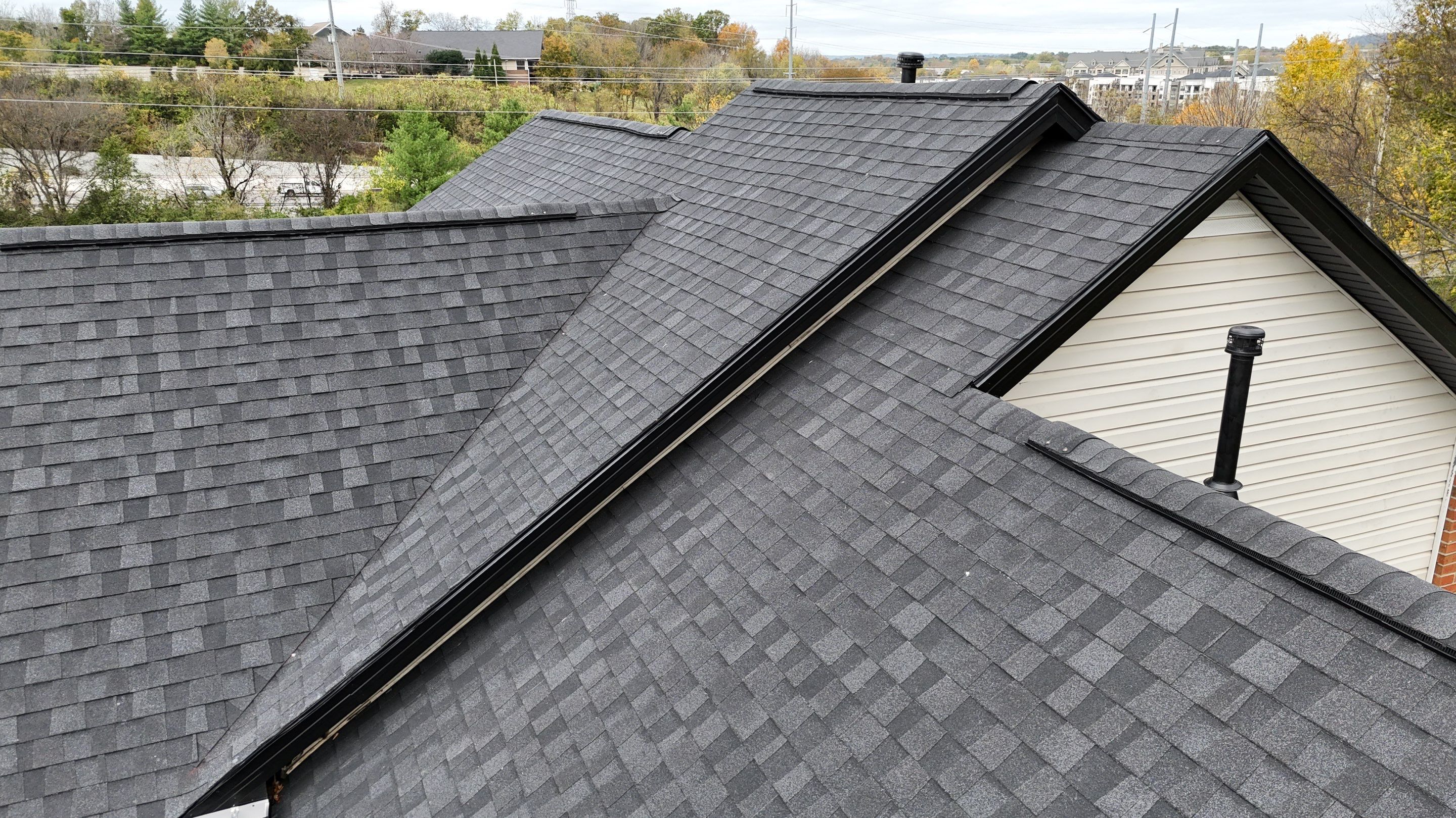 Charcoal Black Re-Roof & Gutters by Royal House LLC
