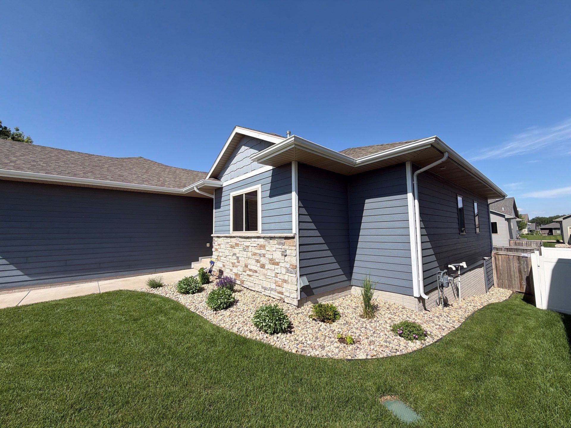 Full Exterior Home Painting on Blue Lap Siding in Sioux Falls by Select Painting, Coatings & Garage Cabinets
