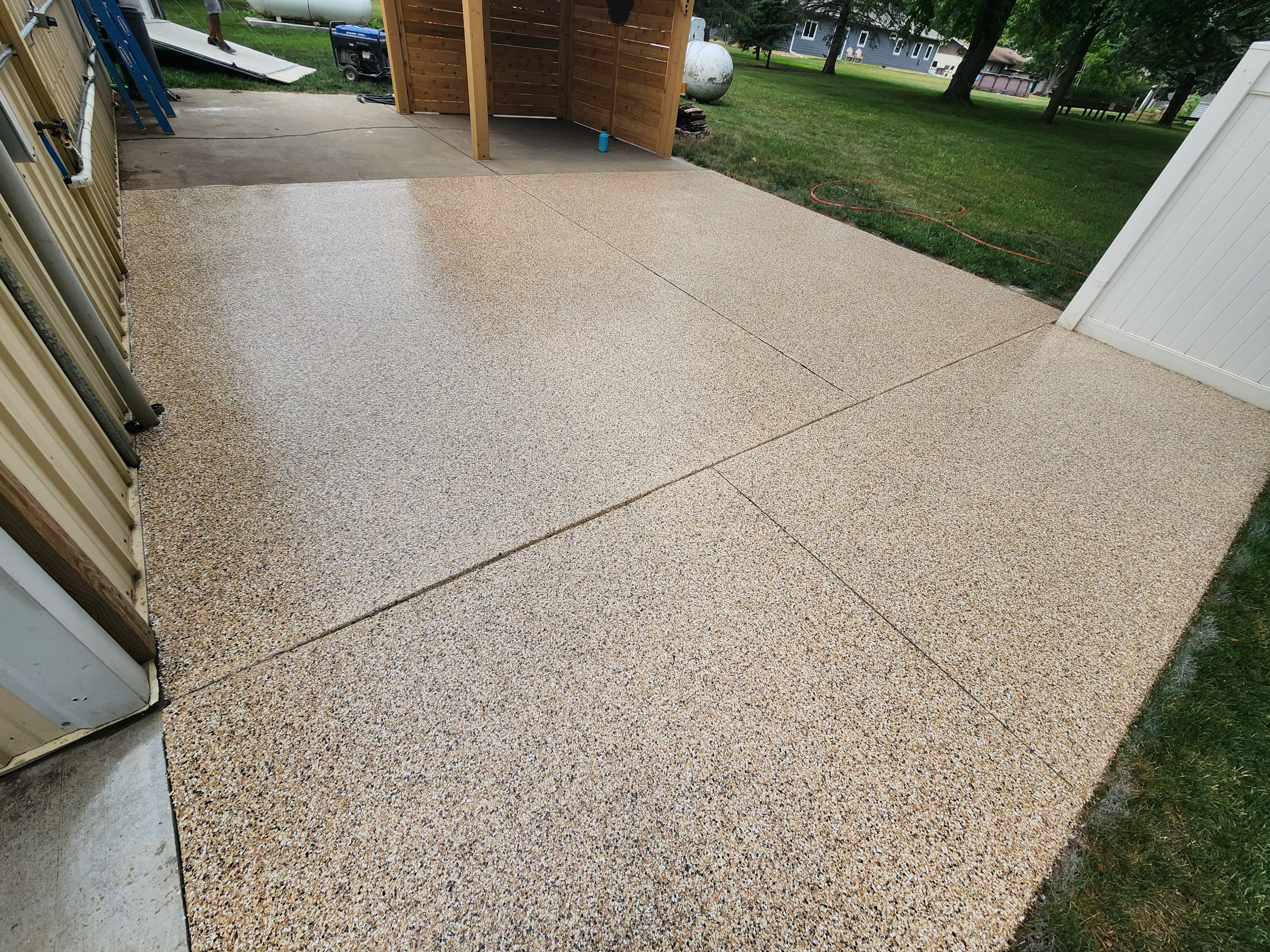 Speckled Epoxy Concrete Patio Coating Installation in Hurley by Select Painting, Coatings & Garage Cabinets