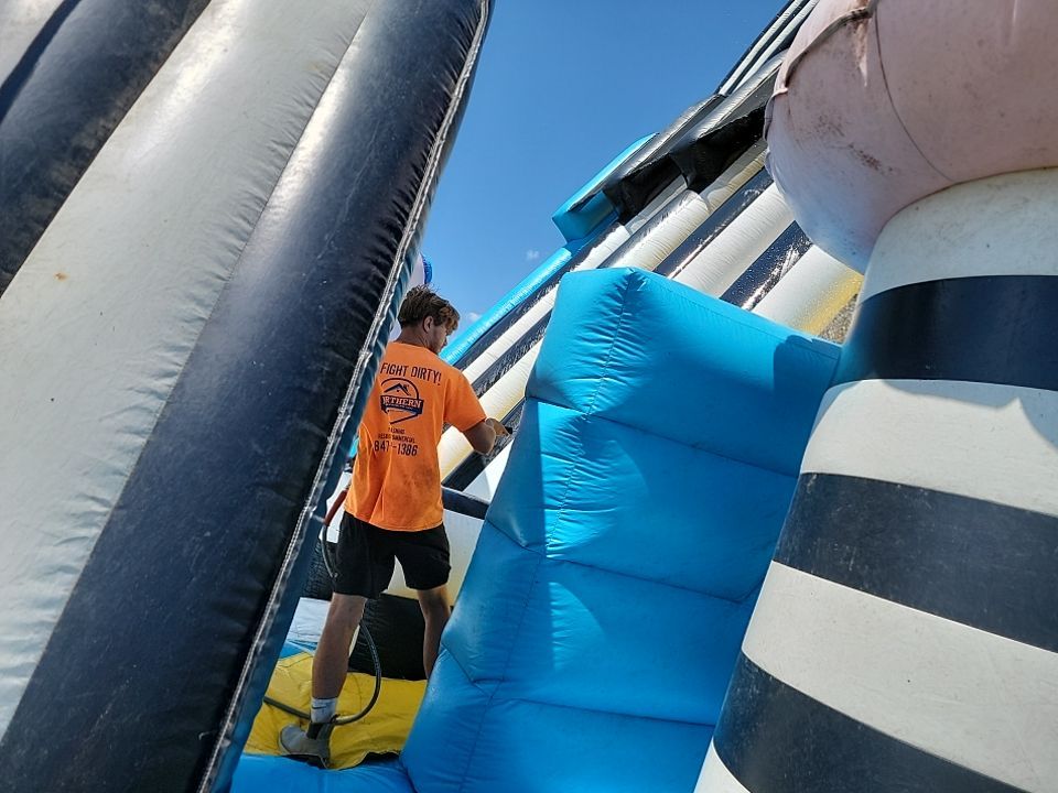 Cleaning for big bounce america prior to a large event by Northern Power Washing LLC.