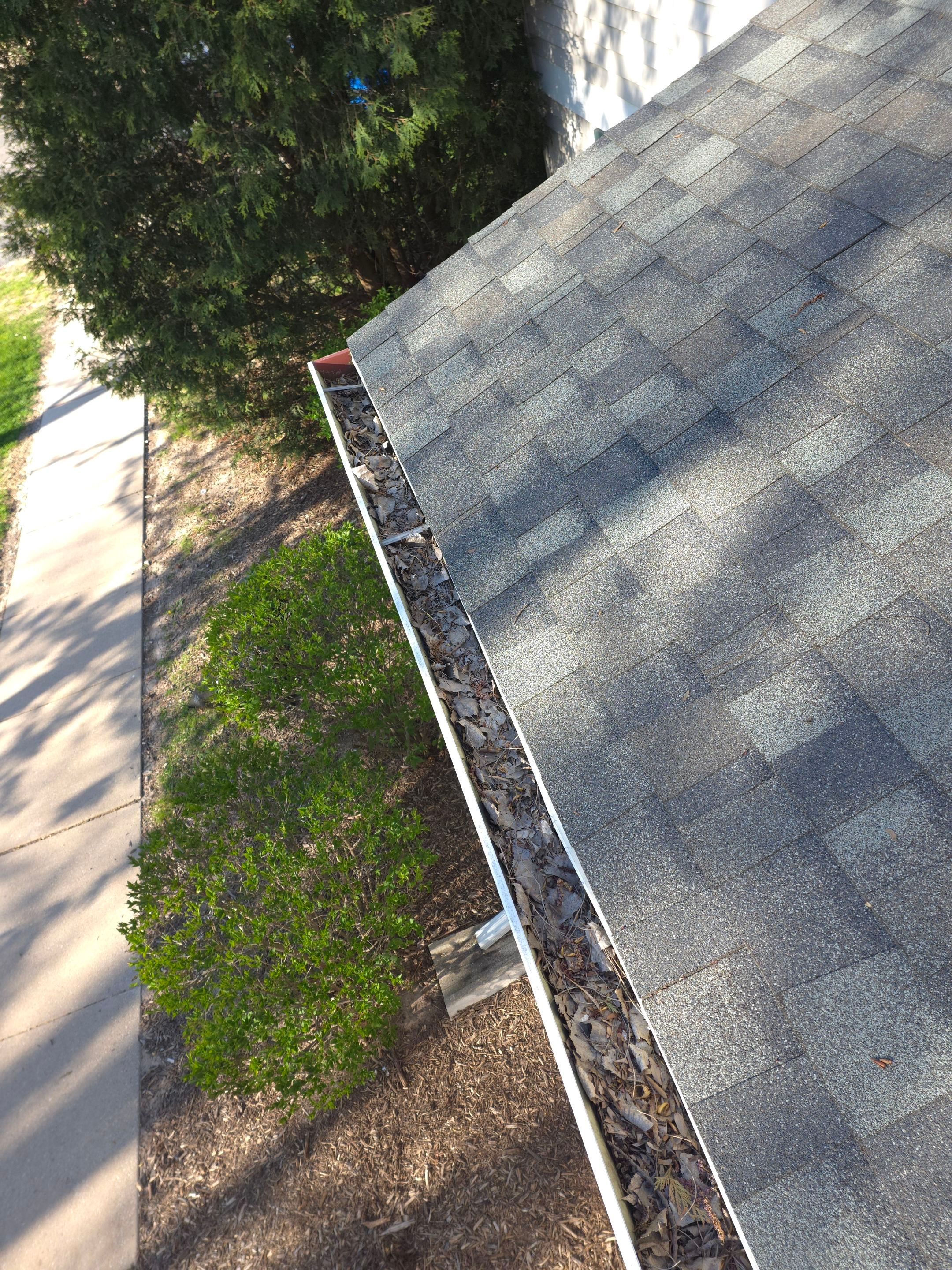 Commercial gutter cleaning Green Bay, WI before photo with filled gutters