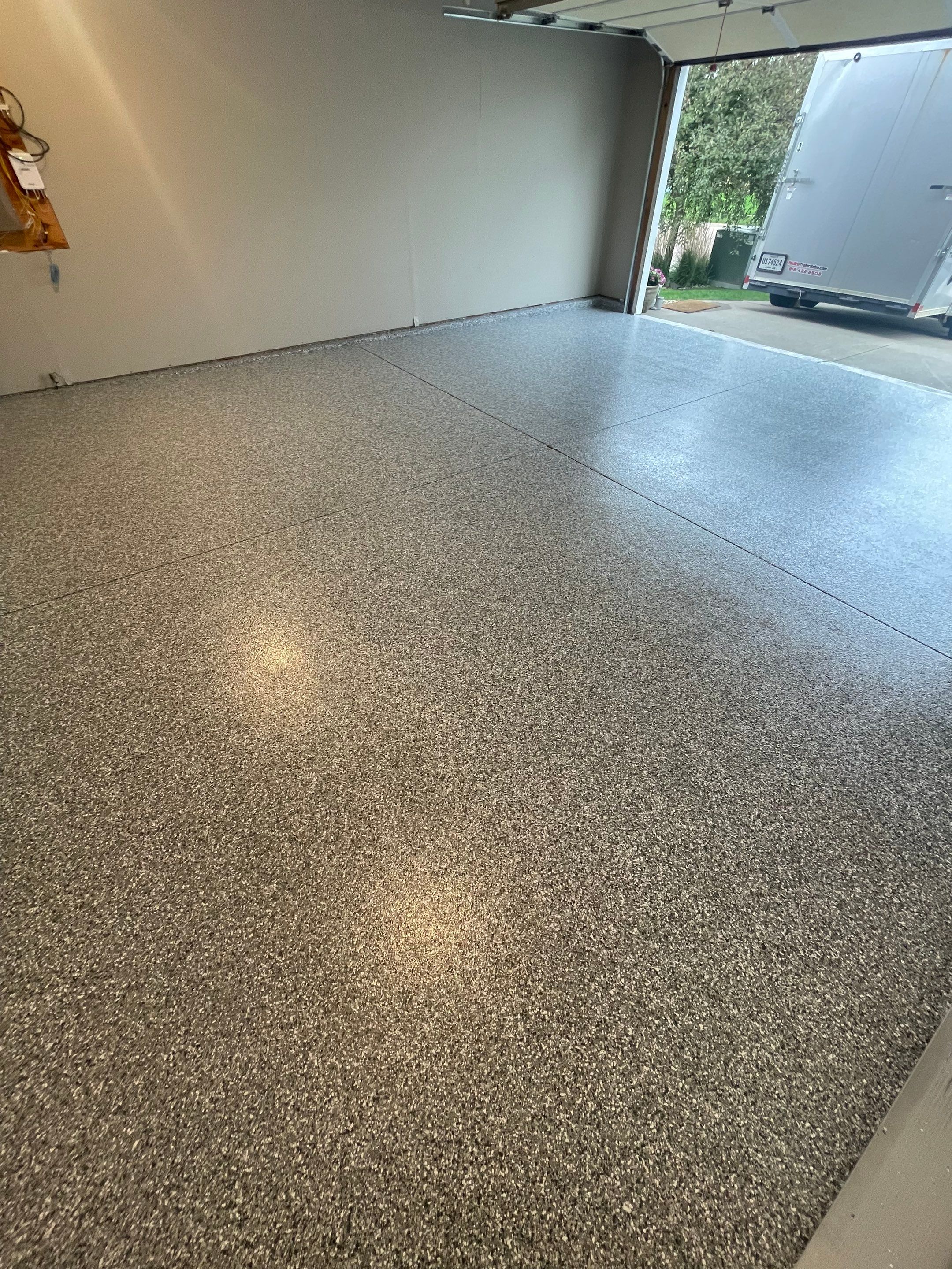 Custom Polyurea Flake Garage Floor Installation in Sioux Falls by Select Painting, Coatings & Garage Cabinets