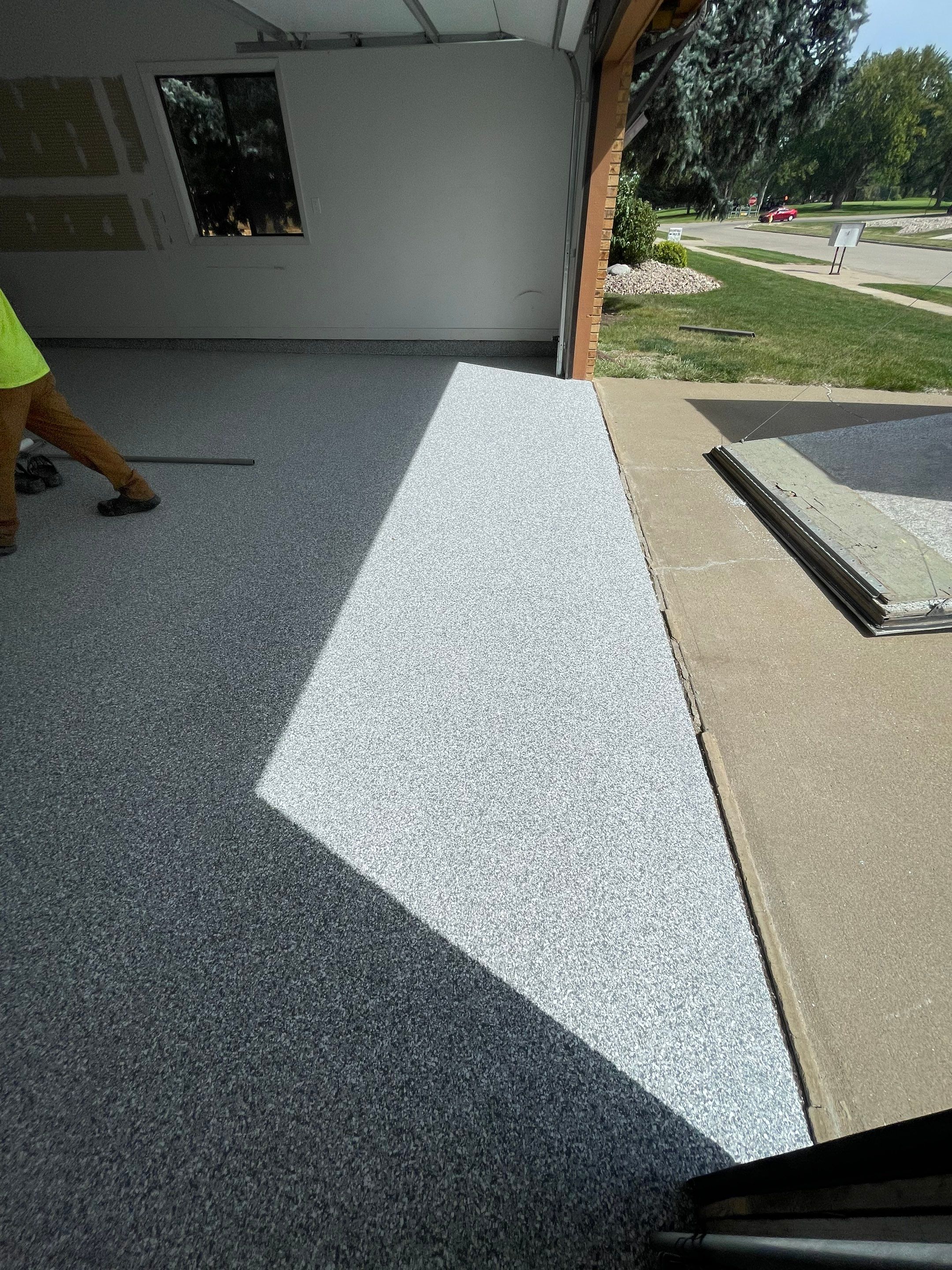 Grey Speckled Concrete Coating for Residential Garage in Yankton by Select Painting, Coatings & Garage Cabinets