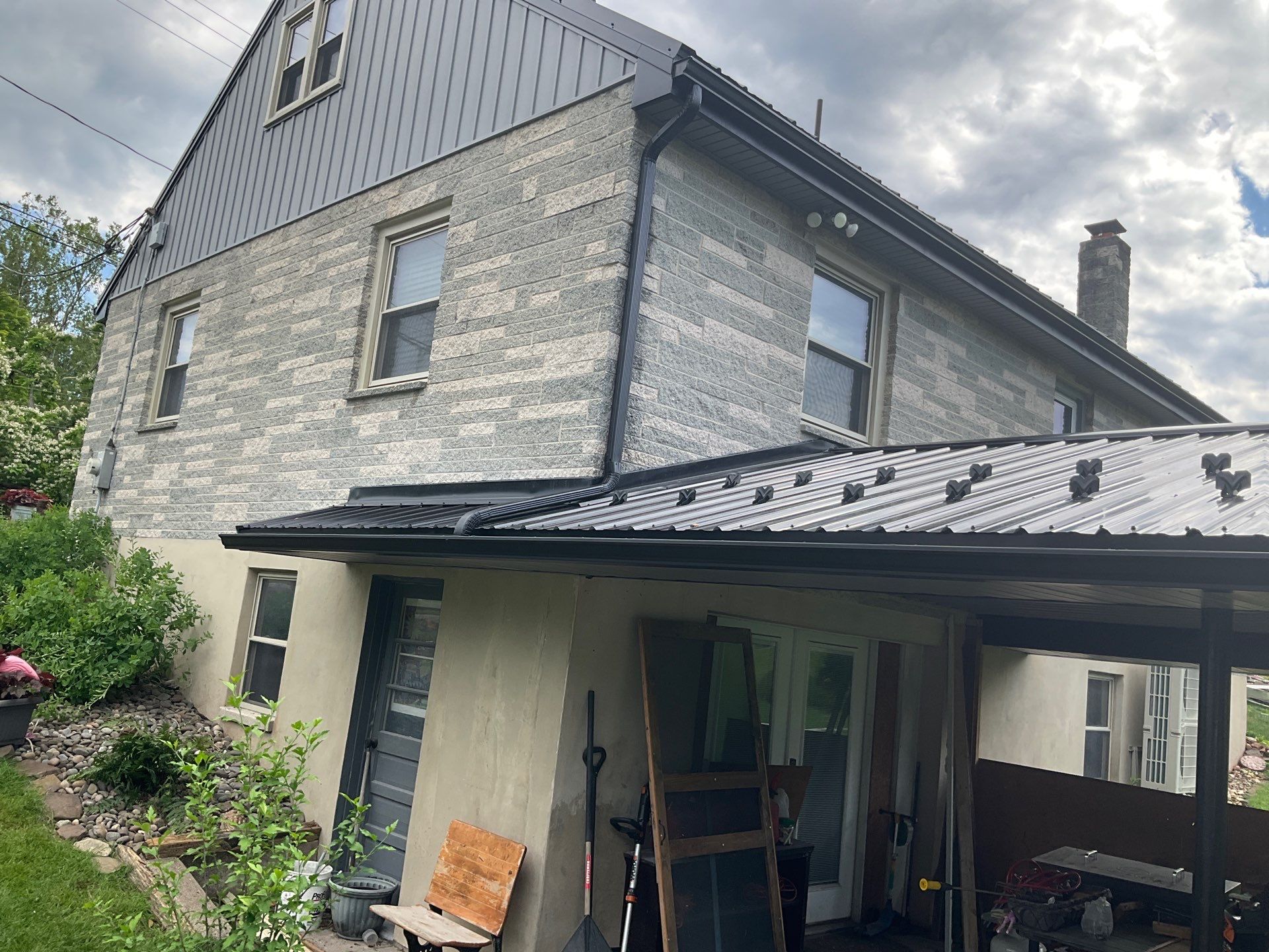Metal Roofing, Board & Batten Siding, and Entry Door Transformation by Esh Builders