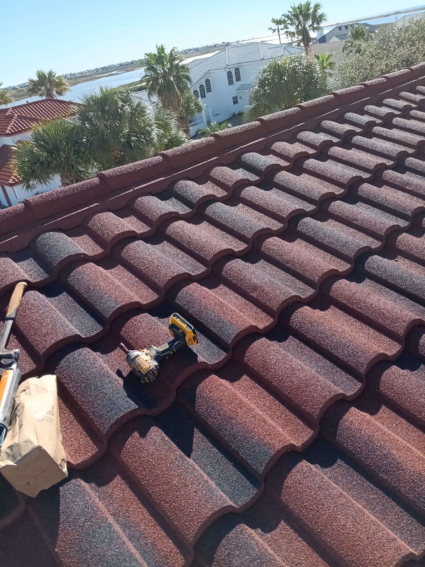 Off with the Tile and on with the TILCOR stone coated metal.  by Bayfront Roofing and Construction