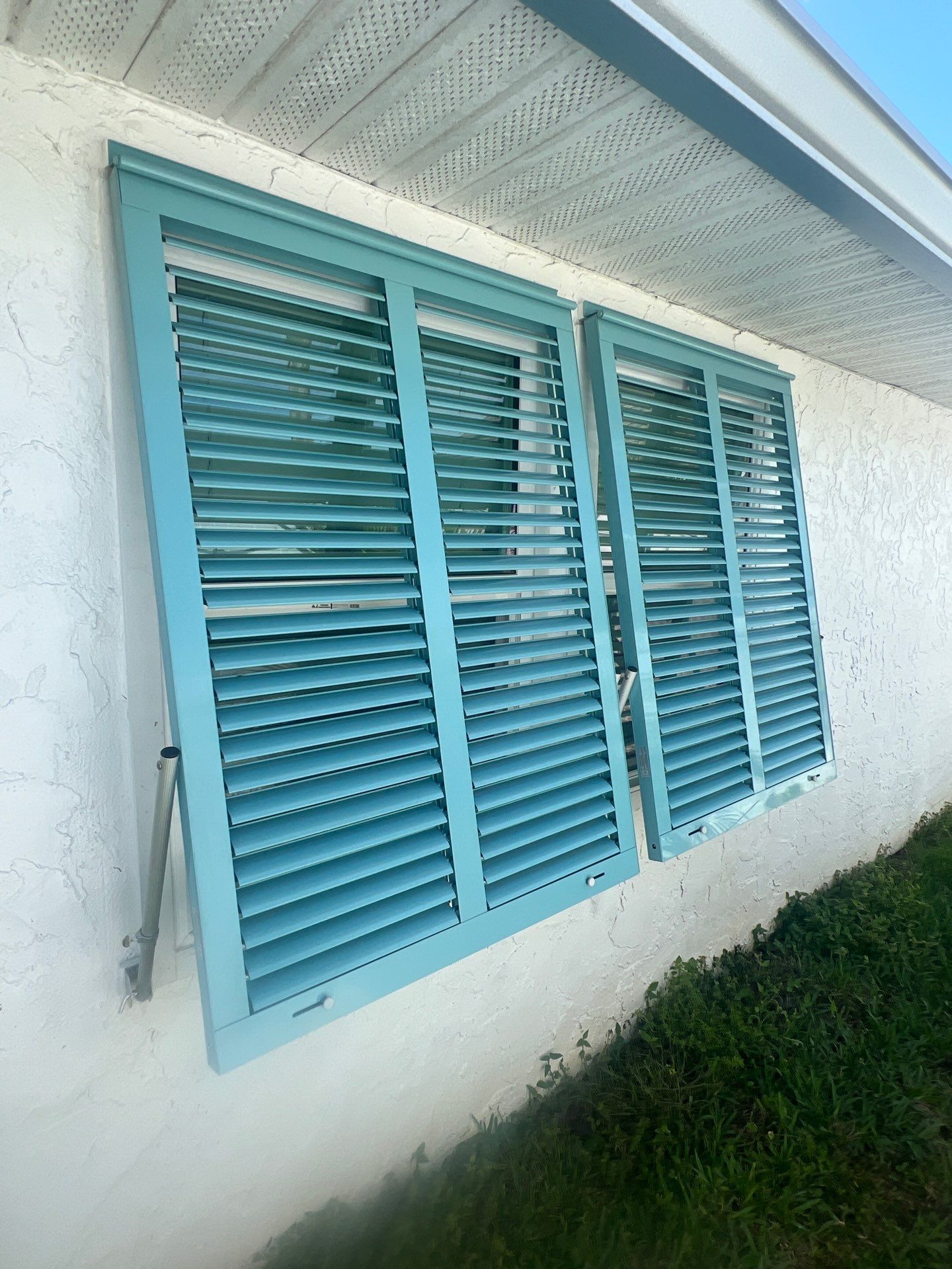 Hurricane Rated Bahama Shutters in Pastel Turquoise  by Smart Guard Shutters