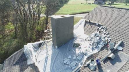 Roof and Gutter System Replacement with Stone Chimney Rebuild by Undersun Roofing 
